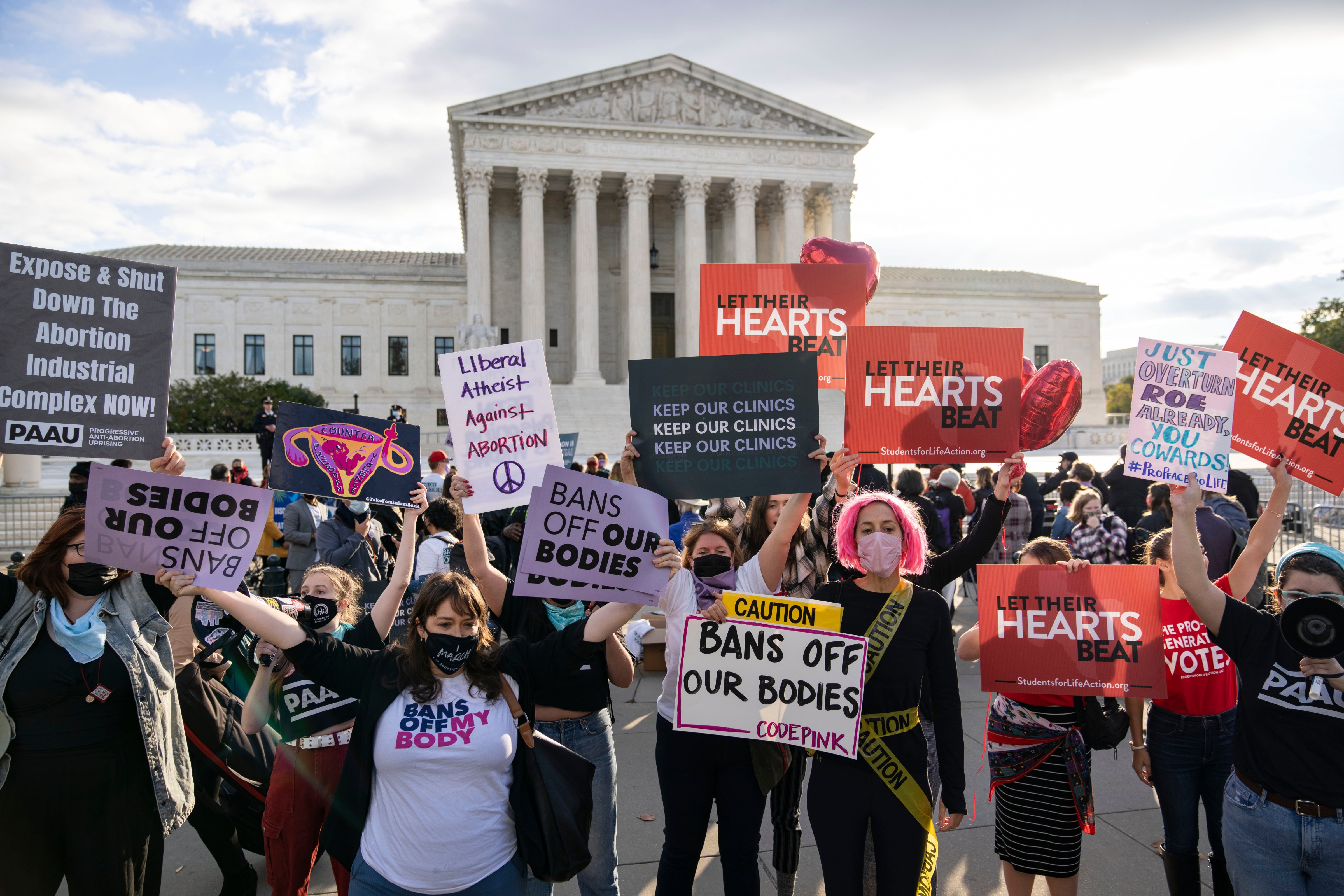 Abortion rights advocates and anti-abortion demonstrators rally outside the Supreme Court on Nov. 1, in Washington, D.C. as the Supreme Court heard arguments in a challenge to the controversial Texas abortion law which bans abortions after about six weeks. (Drew Angerer—Getty Images)