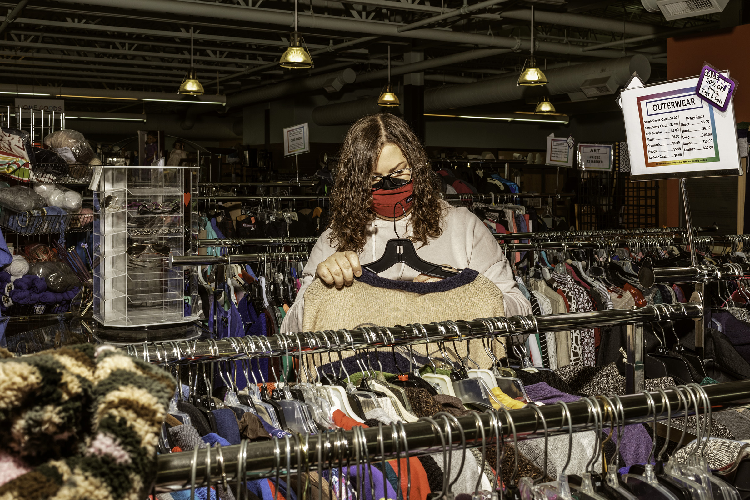 Sarah Urquhart browses the aisles at CommunityWorx Thrift Shop. Sarah tries to avoid buying new items and typically shops for herself and friends at thrift stores throughout the area. (Jeremy M. Lange for TIME)