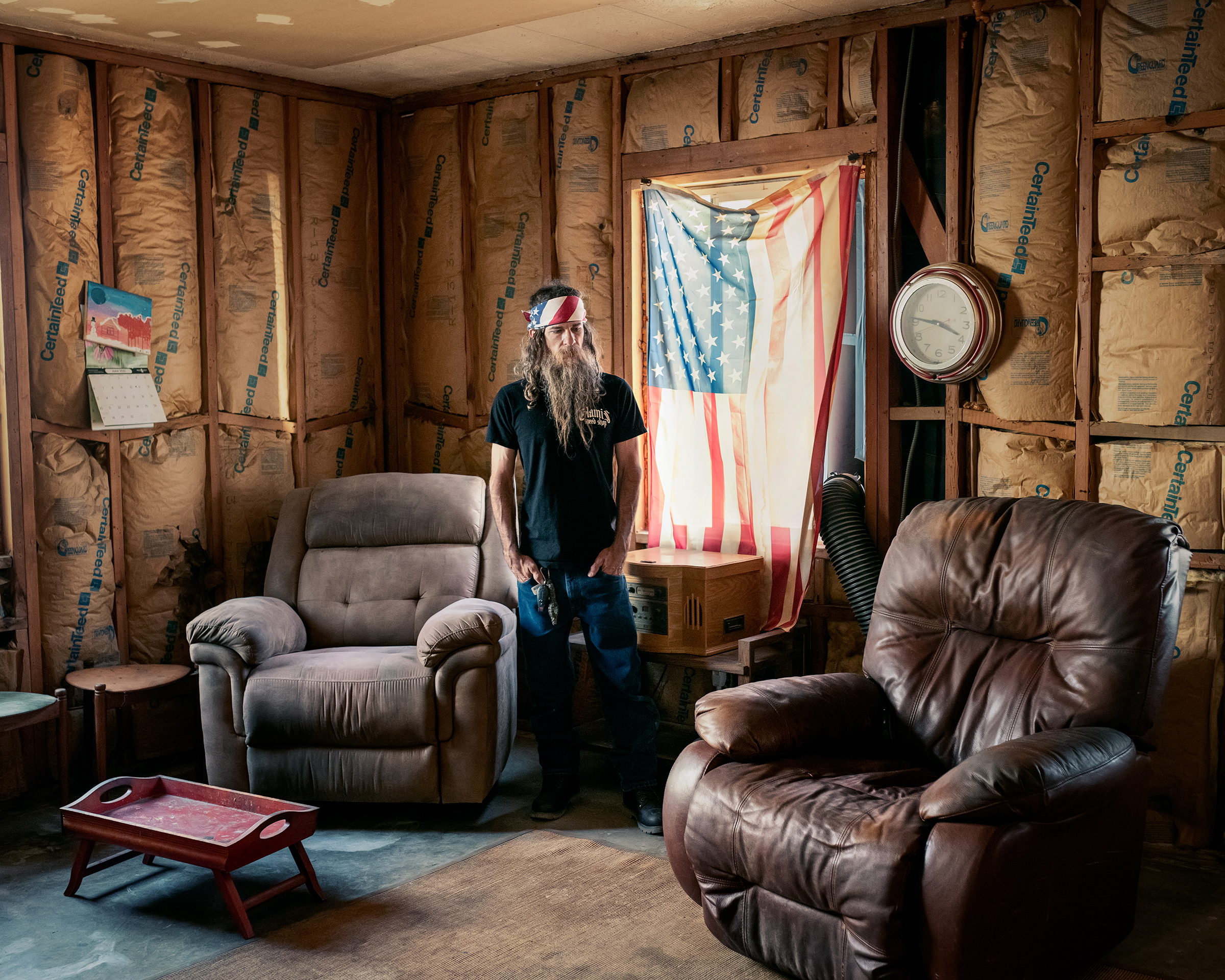 Jody Marquess, 43, looks at the recliner where his stepfather John Ramer <a href="https://time.com/extreme-heat-climate-change/">died</a> in Goodyear, Ariz., on June 17. It was Marquess’s birthday, but he was concerned about the 69-year-old, who eschewed air-conditioning. “He had tough-guy syndrome,” Marquess told TIME six days later, recalling a “stubborn” and “very frugal” but also “honest and simple” man. When Marquess stopped by on June 17—the high reached 118°F—he installed a portable AC unit for Ramer, who was sleeping. Two hours later, when he returned to drop off ice cream, Ramer was dead. From April through July, Maricopa County confirmed 47 heat-associated deaths, more than triple the figure confirmed by the end of the same period last year. Marquess had long wondered if this was how Ramer might die in Arizona: “I just didn’t think it was going to be this soon.” (Adam Ferguson for TIME)