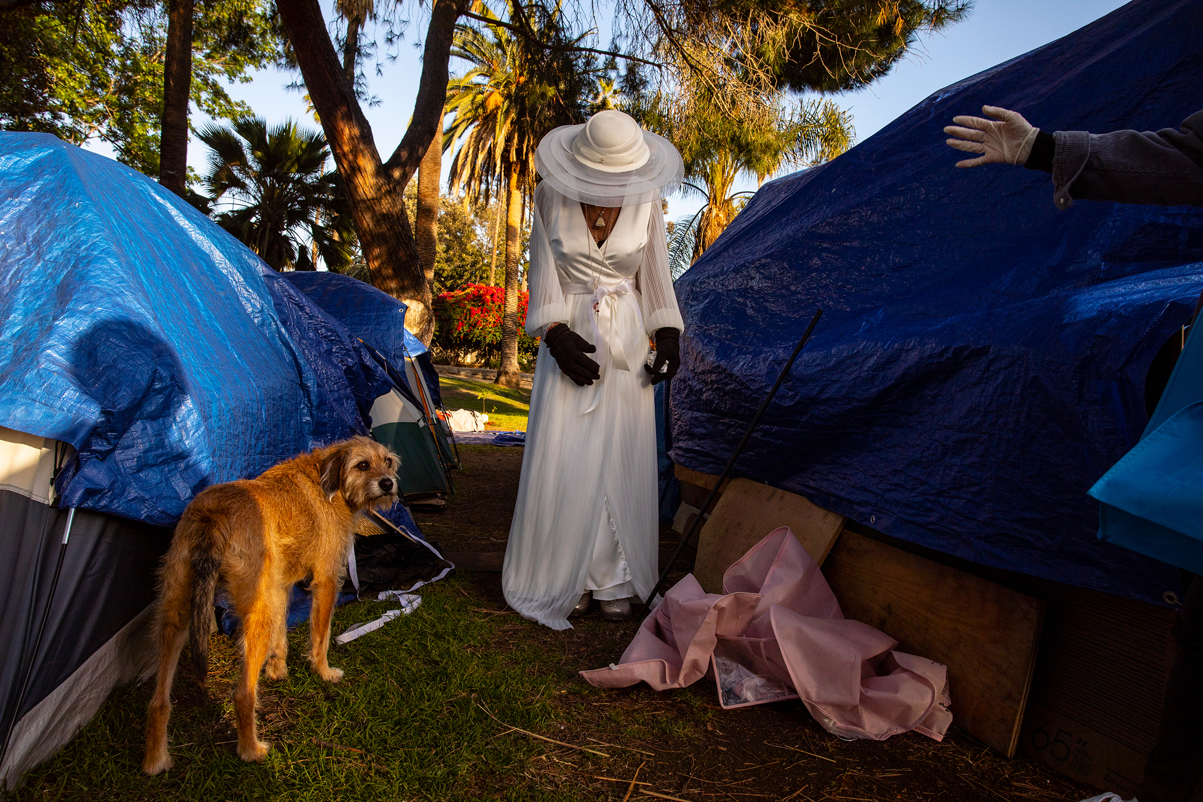Valerie Zeller, 52, cries during her first-ever wedding dress fitting by the side of her tent in Echo Park Lake, in Los Angeles, on March 13, 2021. Heather Yoo, a seamstress with Royal Brides, donated a dress for Zeller and assisted with a fitting a week before the wedding to be sure the alterations would be ready for her special day. Five days after the March 20 wedding, the unhoused community of Echo Park Lake was evicted.