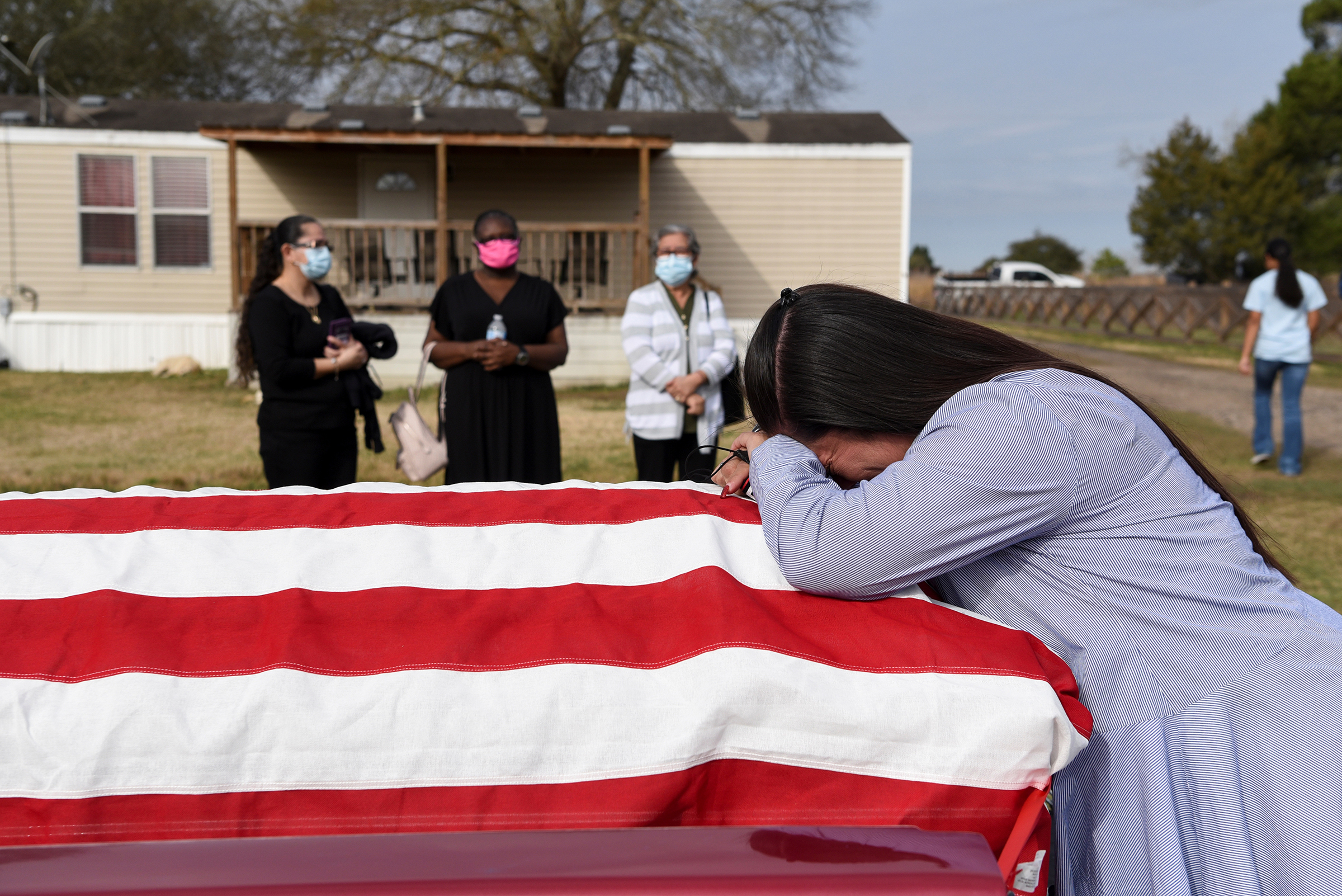 Lila Blanks reacts ahead of the funeral of her husband, Gregory Blanks, 50, who died from COVID-19 complications, in San Felipe, Texas, on Jan. 26. "We need to all do what we need to do to get over it," she said of the pandemic. "So it'll be over and we don't keep burying our husbands, our children, our mothers, our fathers."