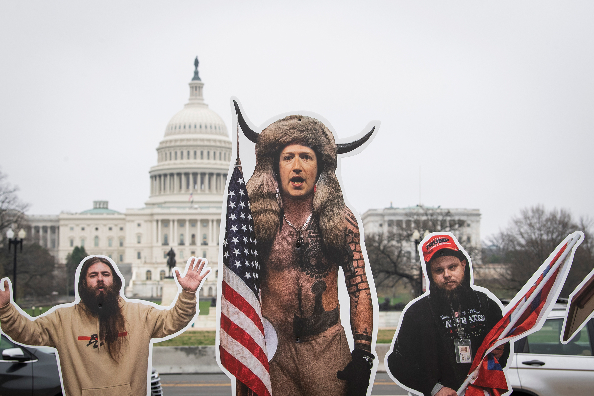 A cardboard cutout of Facebook CEO Mark Zuckerberg, dressed as the QAnon Shaman, along with other cutouts of people involved in the Jan. 6 attack on the Capitol, stand on the National Mall ahead of a House committee hearing on social media and extremism on March 25. The cutouts were placed by the group SumOfUs to highlight the role that social media organizations played in the insurrection.