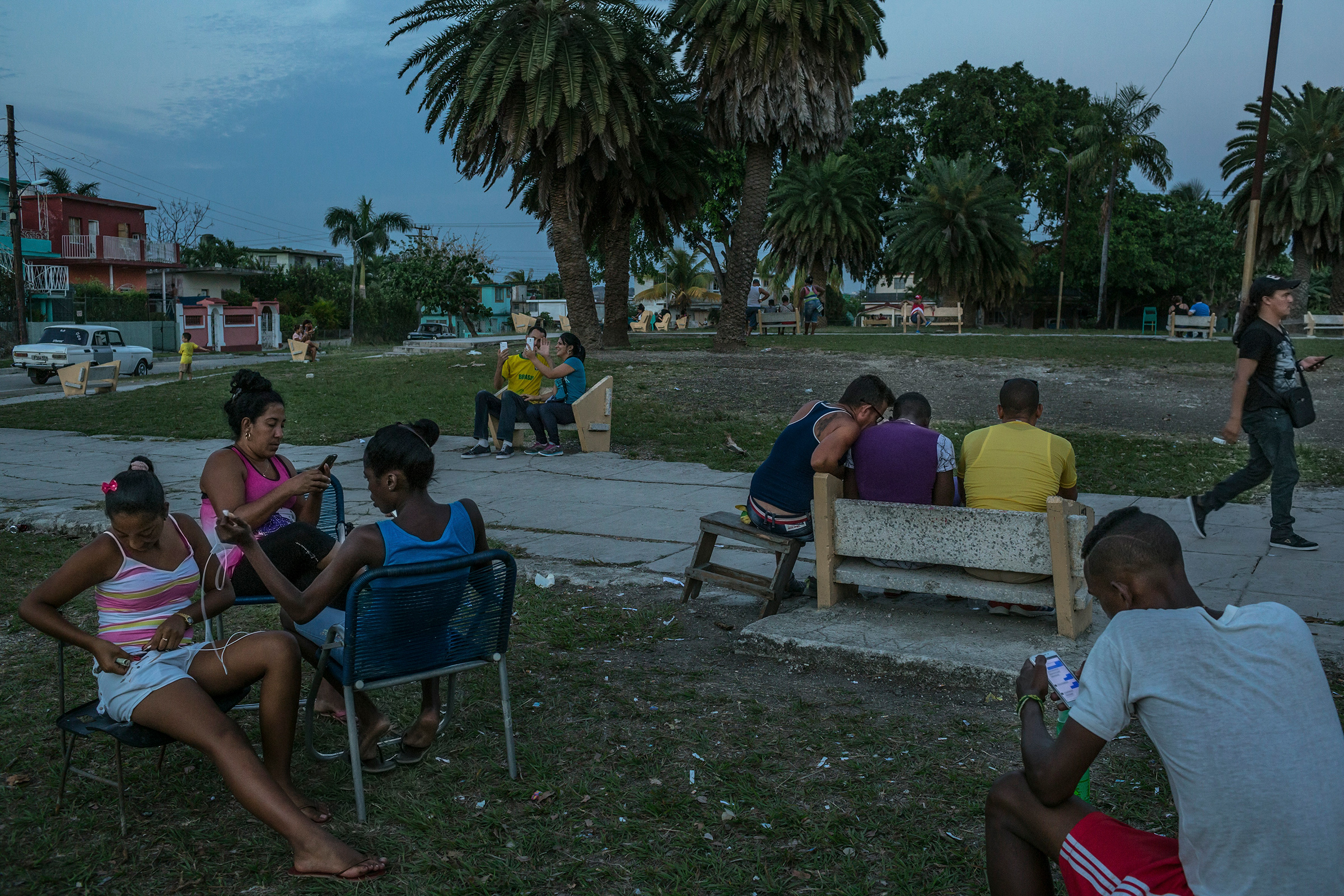 Cubans connecting to the internet using cellphones at a Wi-Fi hot spot in a square on the outskirts of Havana in March 2016. A mobilization of protesters in the Cuban capital in November 2020, was a rare instance of Cubans openly confronting their government -- and a stark example of how having widespread access to the internet through cellphones is testing the power balance between the Cuban regime and its citizens. (Mauricio Lima—The New York Times/Redux)