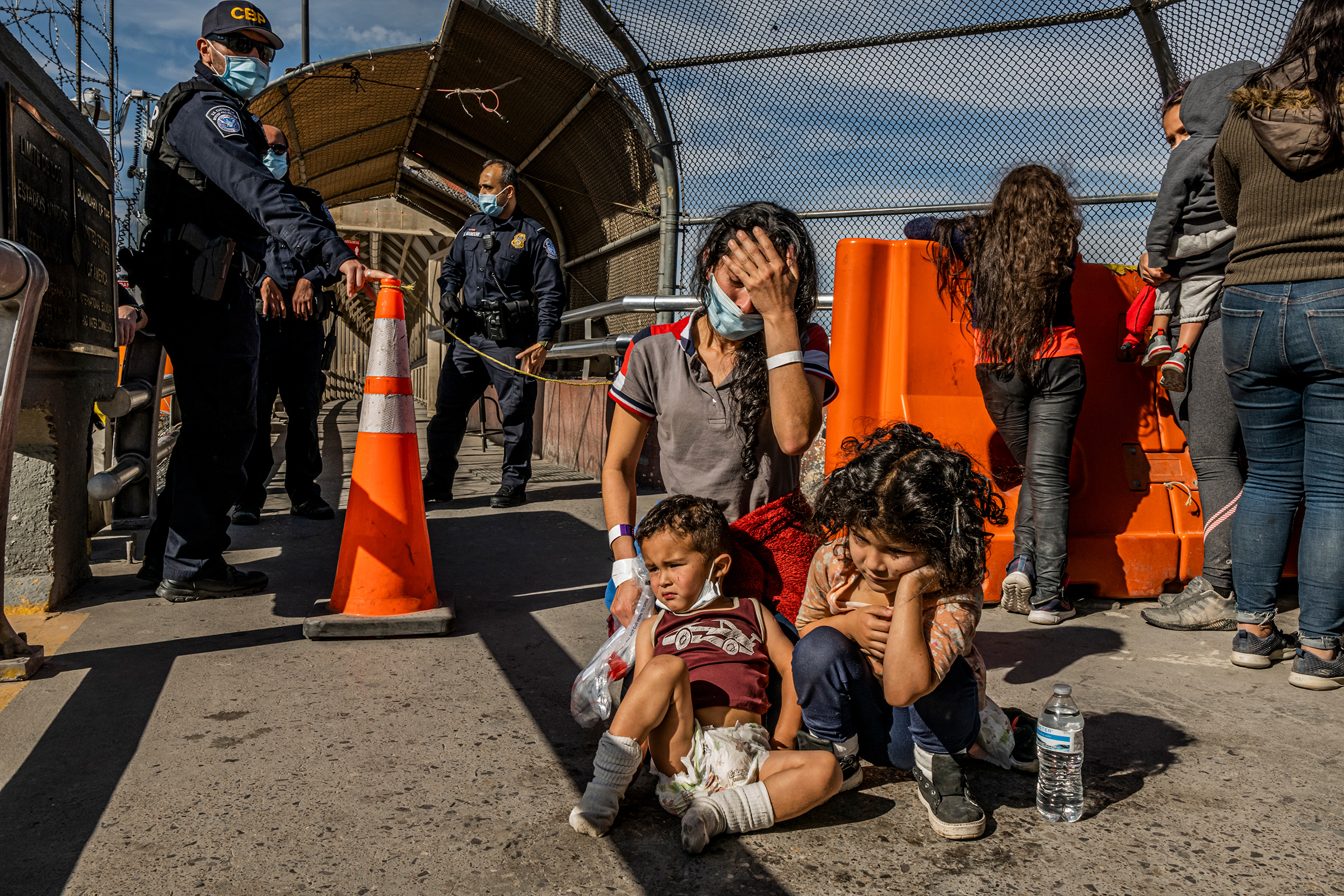 Vilma Iris Peraza, 28, from Honduras cries next to her two children, Adriana, 5, and Erick, 2, after finding out they were <a href="https://www.nytimes.com/2021/03/19/world/americas/mexico-border-deportations.html">back in Mexico</a> on March 18. They had just been escorted by U.S. border patrol agents to the middle of the Paso del Norte International Bridge in Ciudad Juarez. Peraza was planning to reunite with her husband, who had been living in Nashville for two years. (Daniel Berehulak—The New York Times/MAPS)
