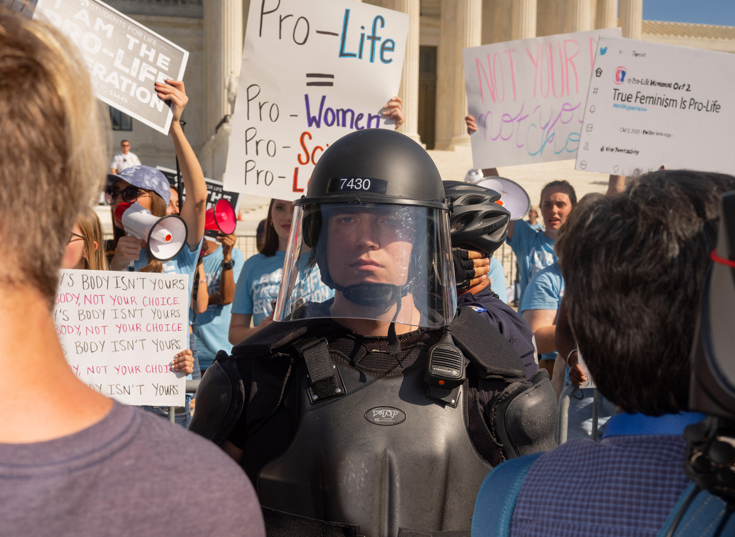 Protesters and counterprotesters meet outside of the Supreme Court at the Women's March and Rally for Abortion Justice in Washington, D.C., on Oct. 2. With counterprotesters situated closer to the building, a security officer stands in between the groups.