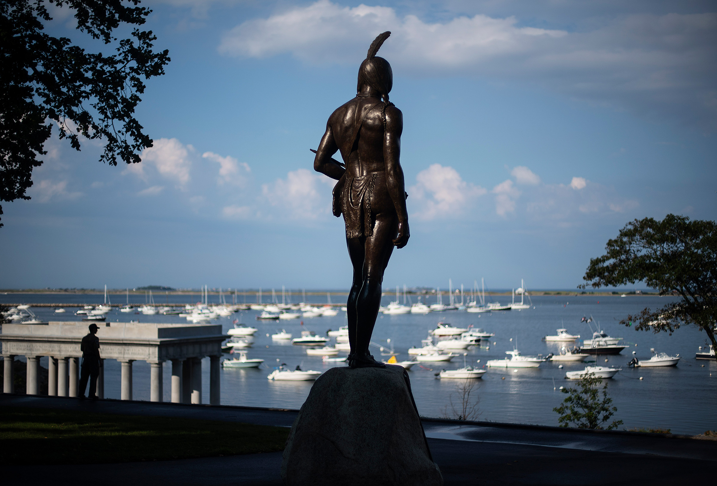 A statue of the Native Sachem (leader) Massasoit looks out over the traditional point of arrival of the Pilgrims on the Mayflower in 1620, in Plymouth, Mass., Aug. 12, 2020.
