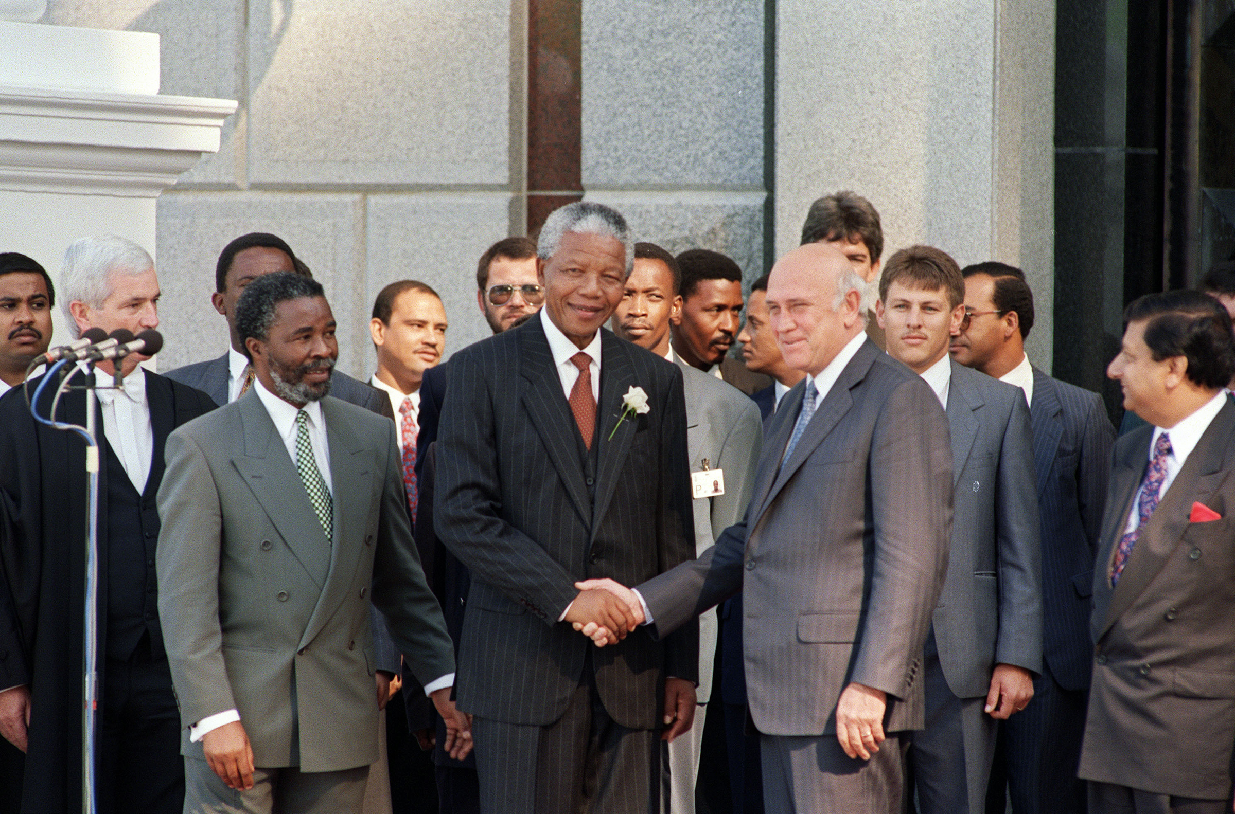 South African President Nelson Mandela shakes hands with F.W. de Klerk, the former president and one of Mandela's deputy presidents, after the inaugural sitting in May 1994