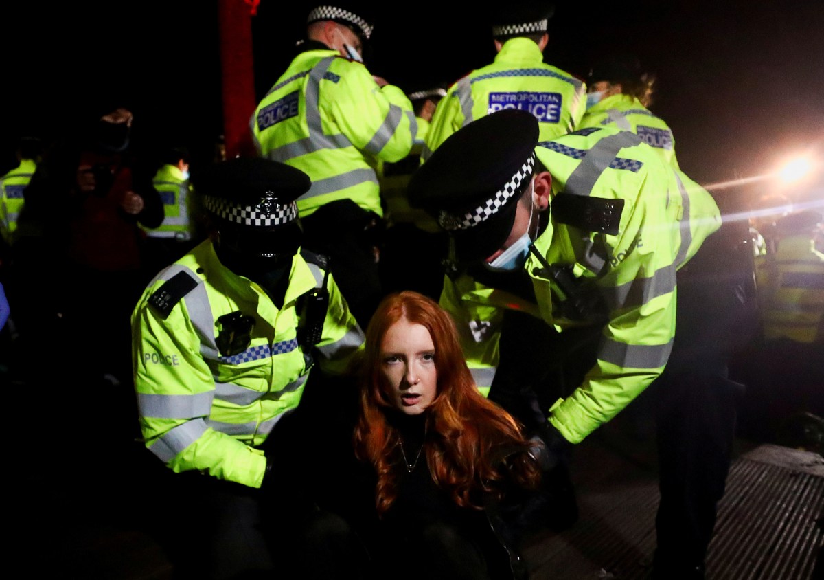 Police detain Patsy Stevenson as people gather at a memorial site in Clapham Common, following the kidnap and murder of Sarah Everard, in London on March 13. A serving officer with London's Metropolitan Police was charged with Everardâs kidnap and murder.