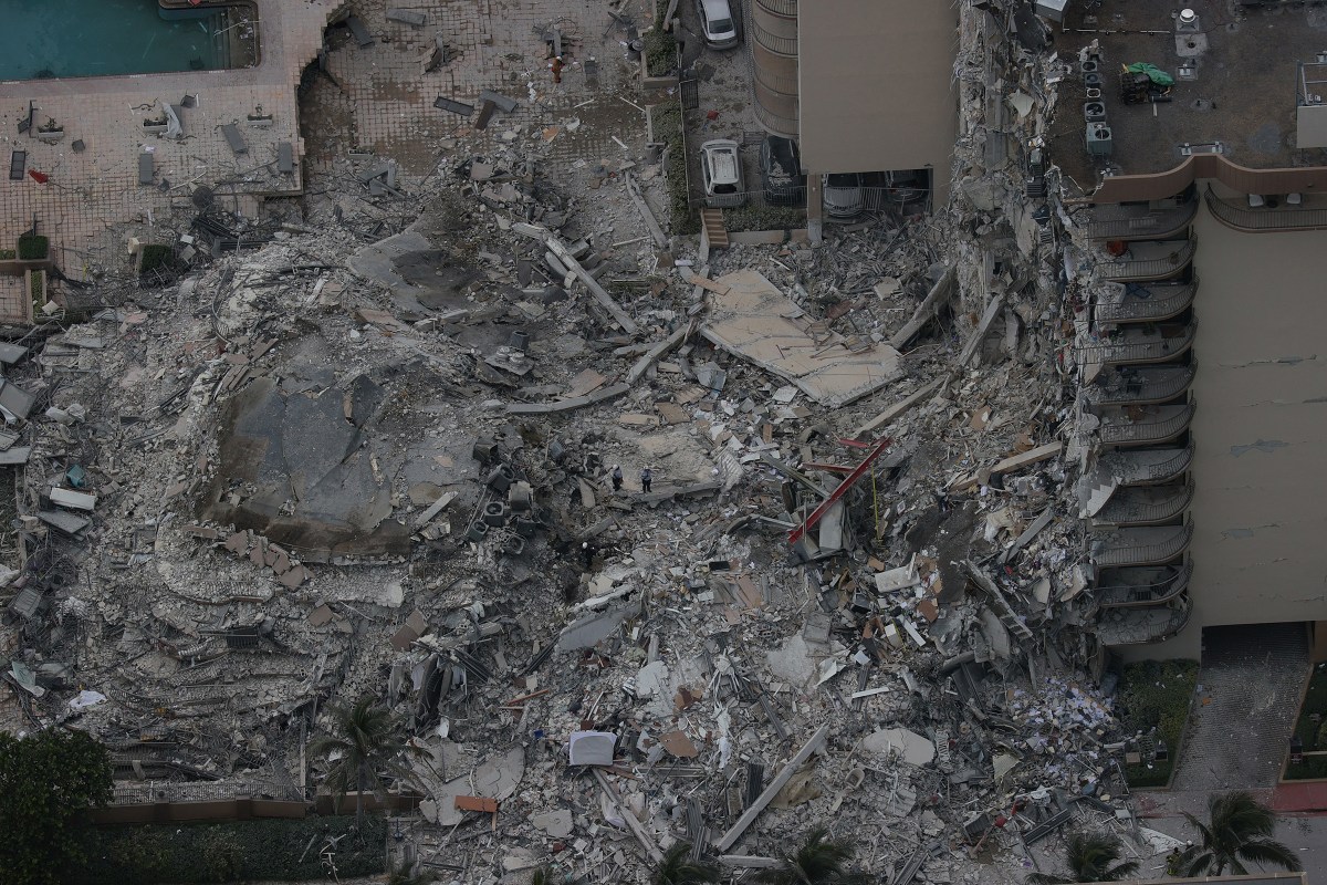 Search-and-rescue personnel work in the rubble of the 12-story condo tower in Surfside, Fla., a suburb of Miami, on June 24, 2021. Ninety-eight people died after the overnight partial collapse.
