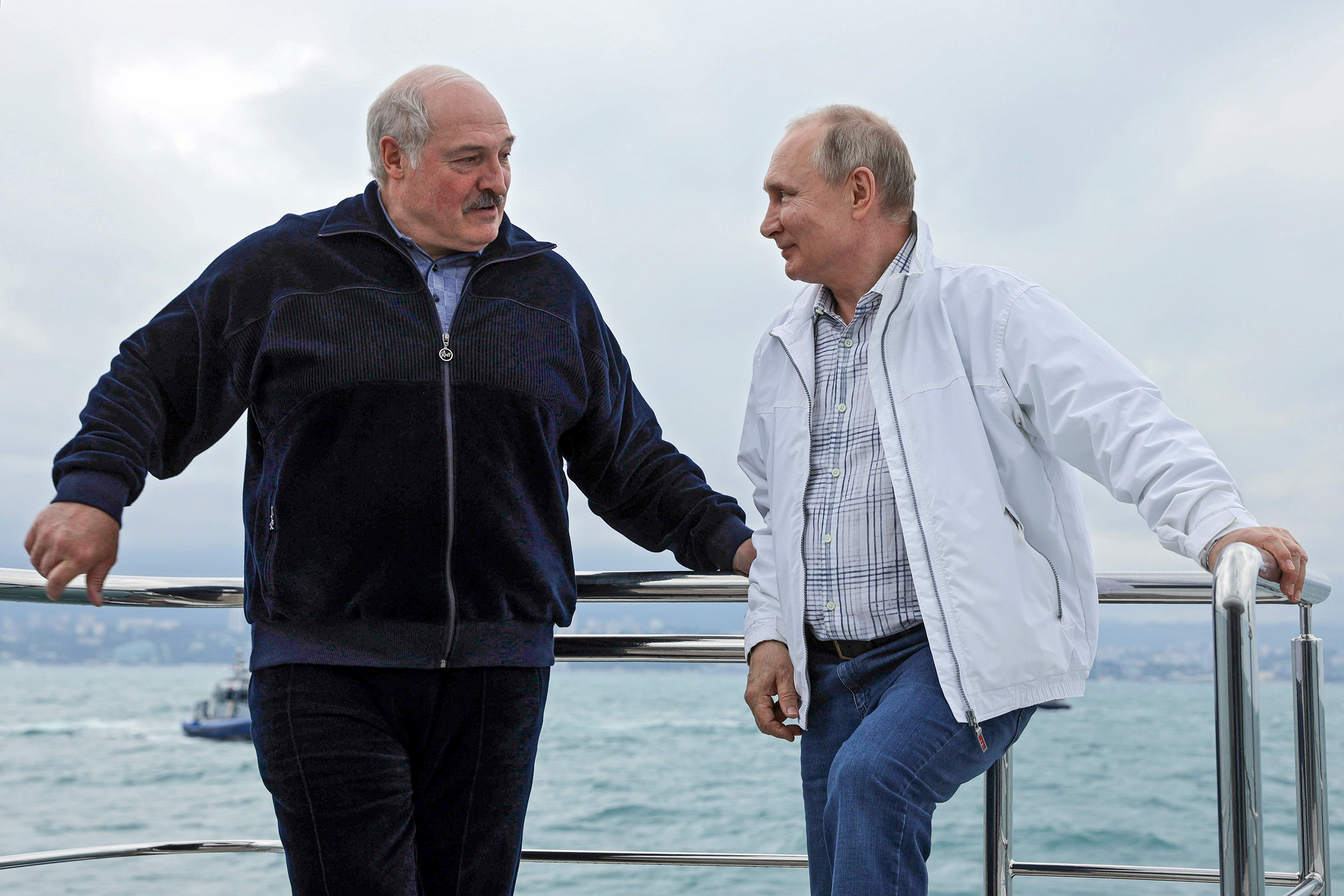 Russian President Vladimir Putin and Lukashenko talks to each other standing on the boat during their meeting in the Black Sea resort of Sochi on May 29. (Sergei Ilyin—Sputnik/Kremlin Pool Photo/AP)