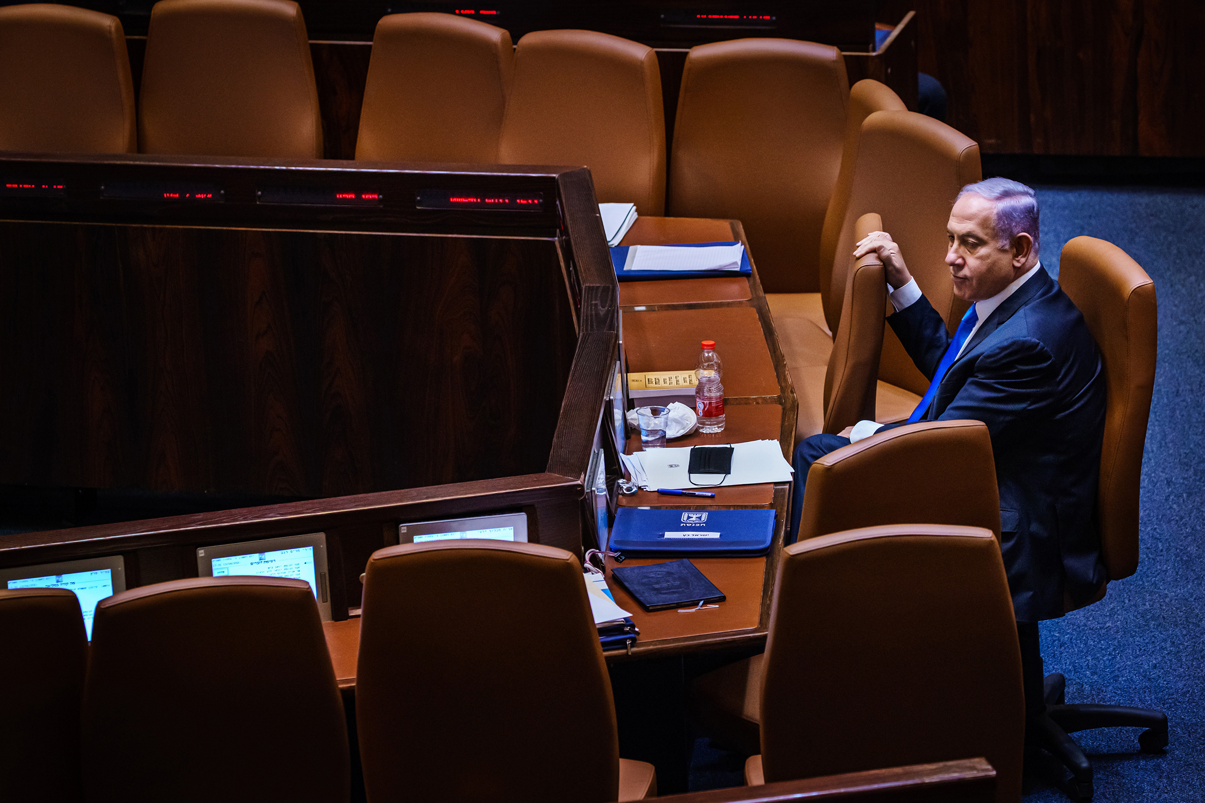 Benjamin Netanyahu takes a look around the empty seats as members of the Knesset, Israel's Parliament, step out for a break in Jerusalem on June 13 before returning to cast their vote of confidence to empower the new coalition government and unseat him as the country's longest-serving prime minister.