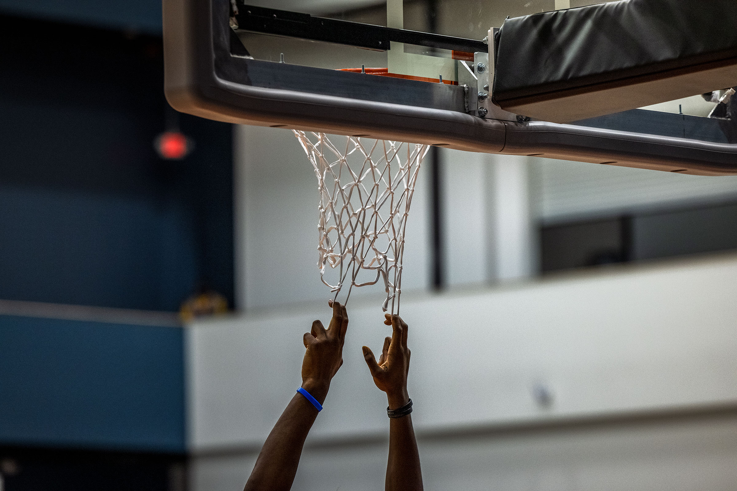 A player hangs onto the net at the OTE practice courts. (Andrew Hetherington for TIME)