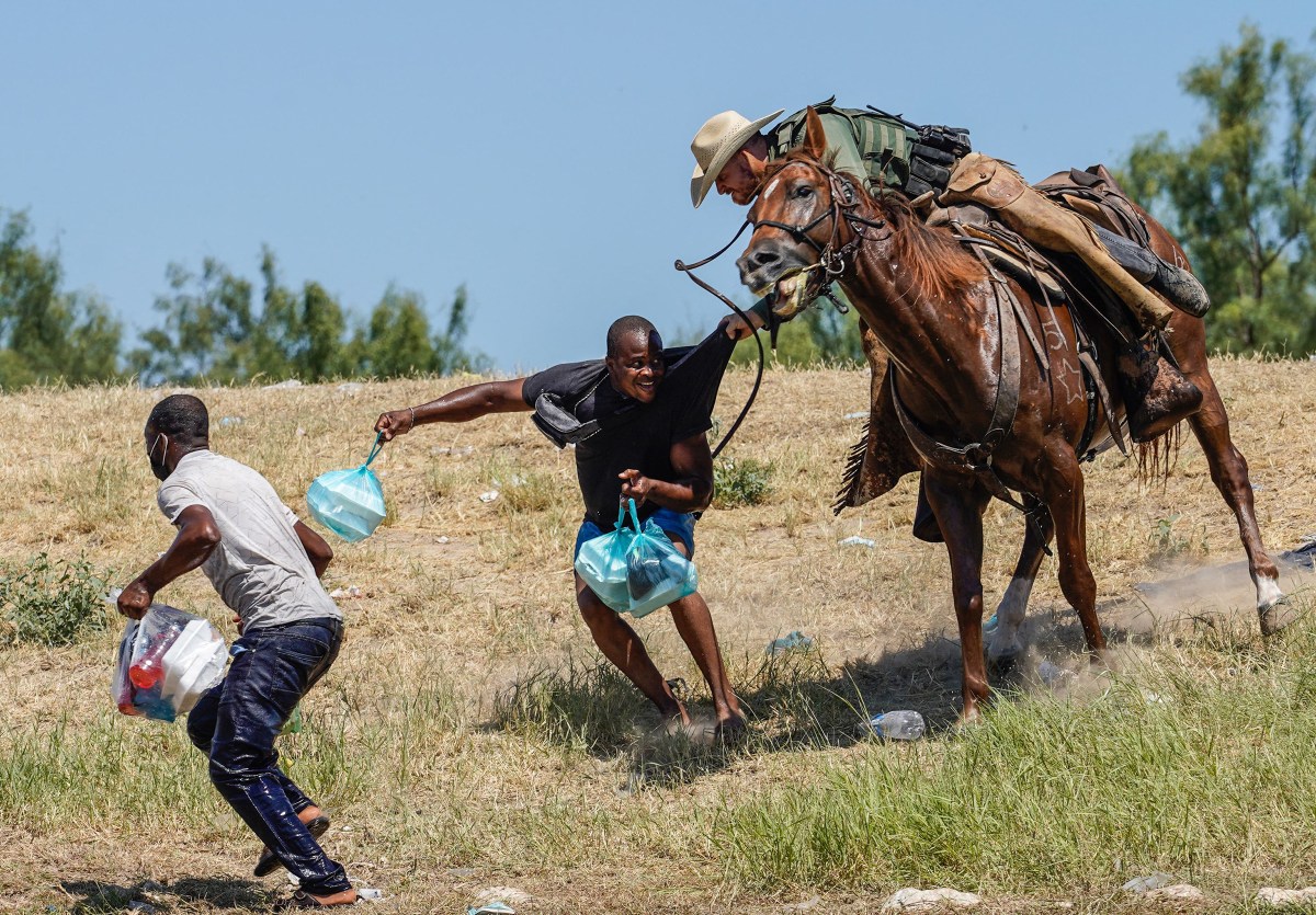 A U.S. Border Patrol agent grabs the shirt of a Haitian man while trying to stop migrants at the U.S.-Mexico border from crossing into Texas, on Sept.Â 19. Images of mounted agents chasing migrants and brandishing whiplike reins prompted the White House to label the scenes âhorrific.â The Department of Homeland Security is investigating.