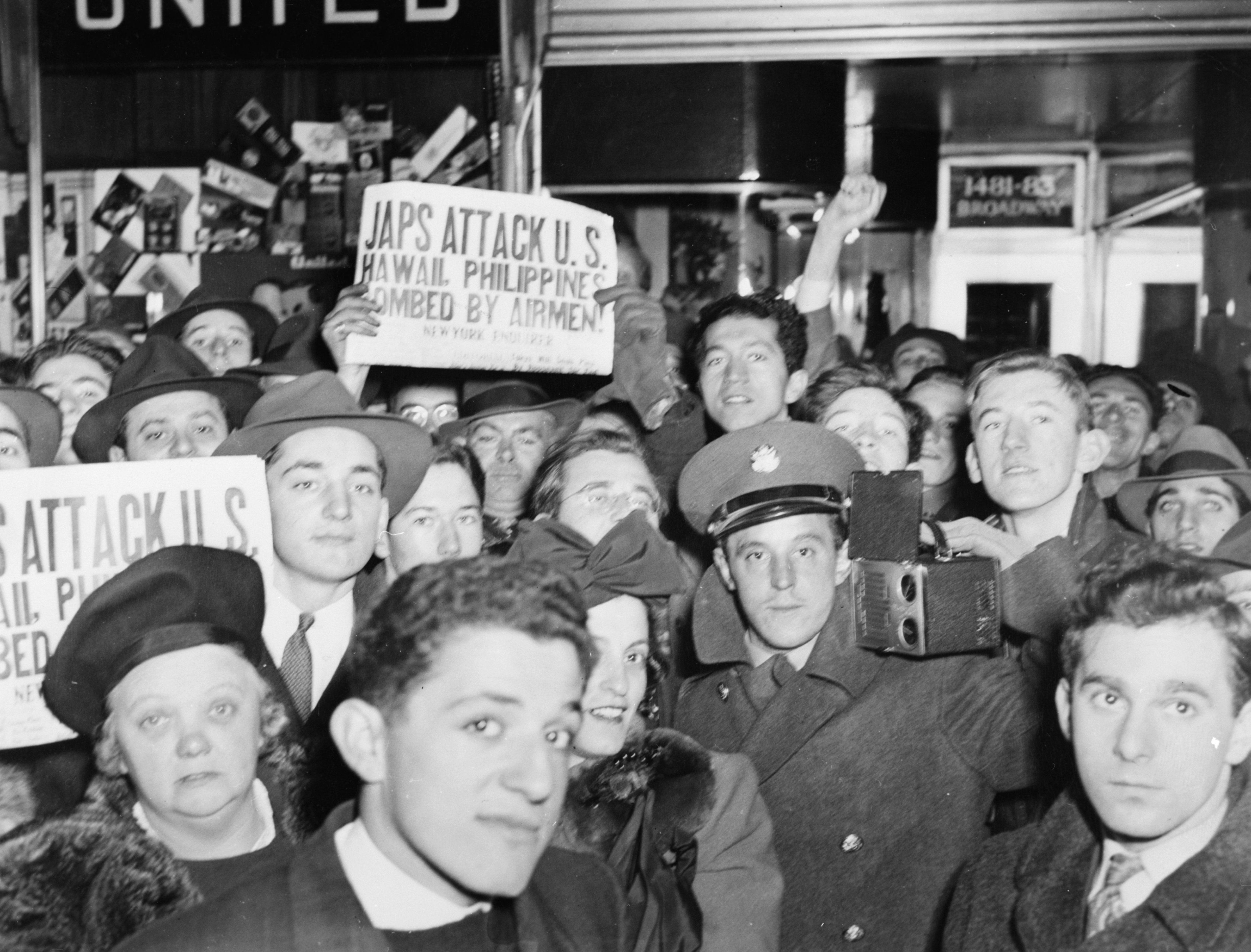 A crowd on Broadway, New York, hold up newspapers announcing the Japanese attack on Pearl Harbor on Dec. 7 1941. (Arthur Fellig—International Center of Photography/Getty Images)