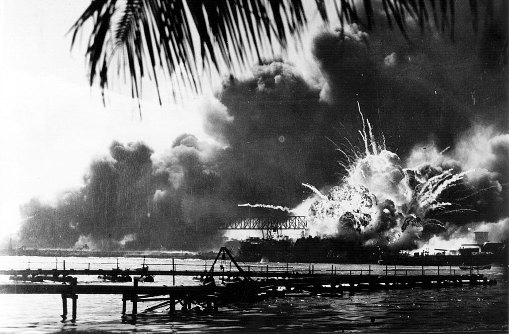 The American destroyer <em>USS Shaw</em> explodes during the Japanese attack on Pearl Harbor, home of the American Pacific Fleet during World War II, December 7, 1941. (Keystone/Hulton Archive—Getty Images)
