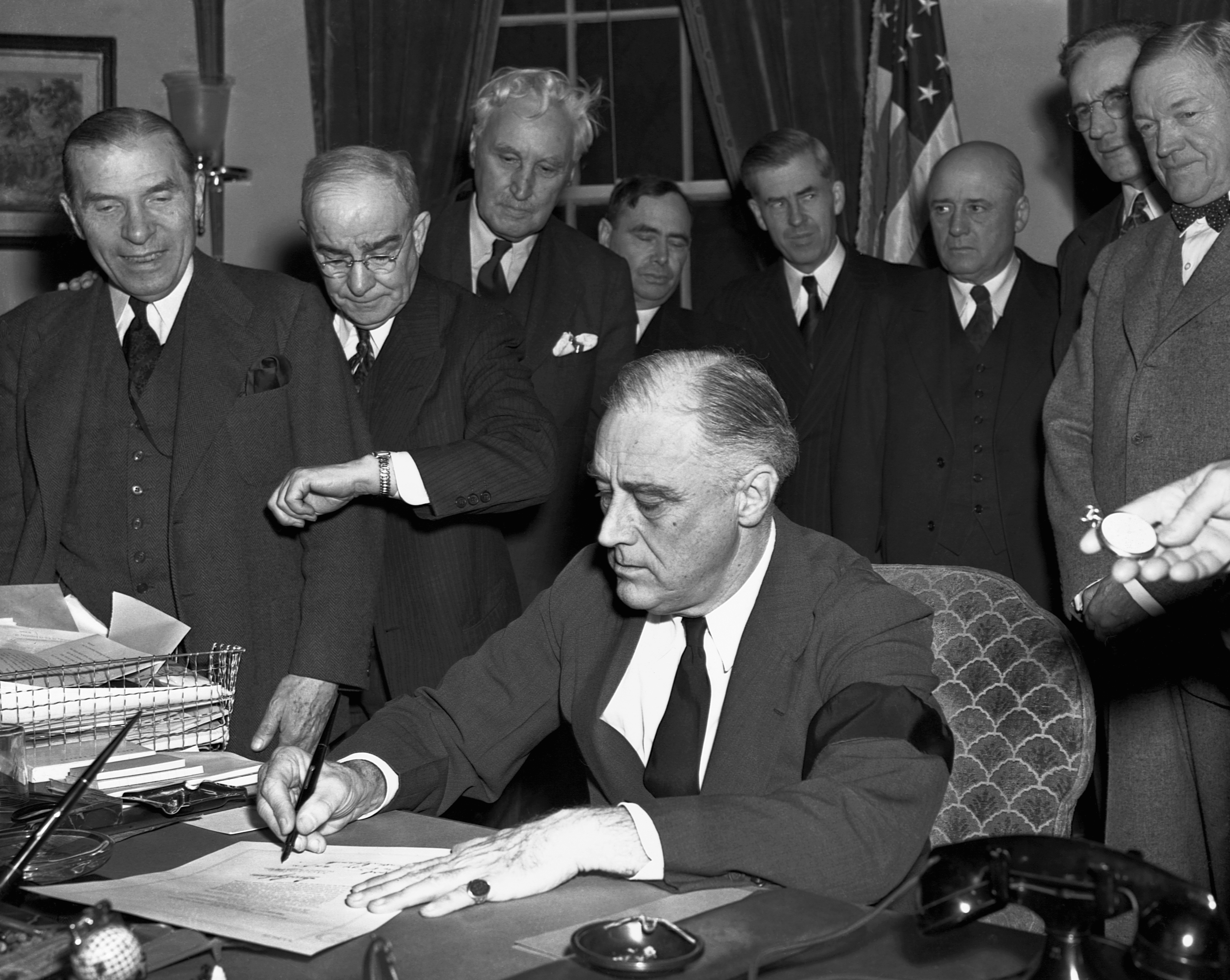 Cabinet members as President Franklin D. Roosevelt signs a declaration of war against Japan on Dec. 8, 1941. (Bettmann Archive—Getty Images)