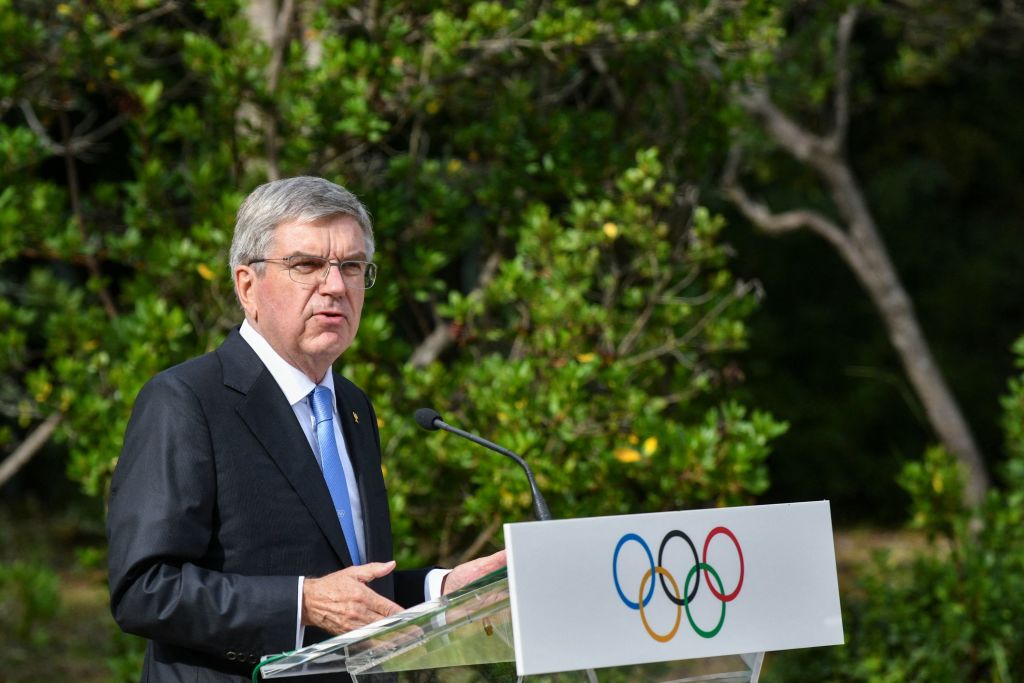 President of the International Olympic Committee (IOC) Thomas Bach speaks during a ceremony of the 100-year anniversary of the IOC Executive Board at the monument of Pierre de Coubertin, the founder of the International Olympic Committee, at the Olympic Academy in Ancient Olympia, birthplace of the ancient Olympics in southern Greece on October 17, 2021, a day before the flame-lighting ceremony for the Beijing 2022 Winter Olympics. (Valerie Gache—AFP/Getty Images)