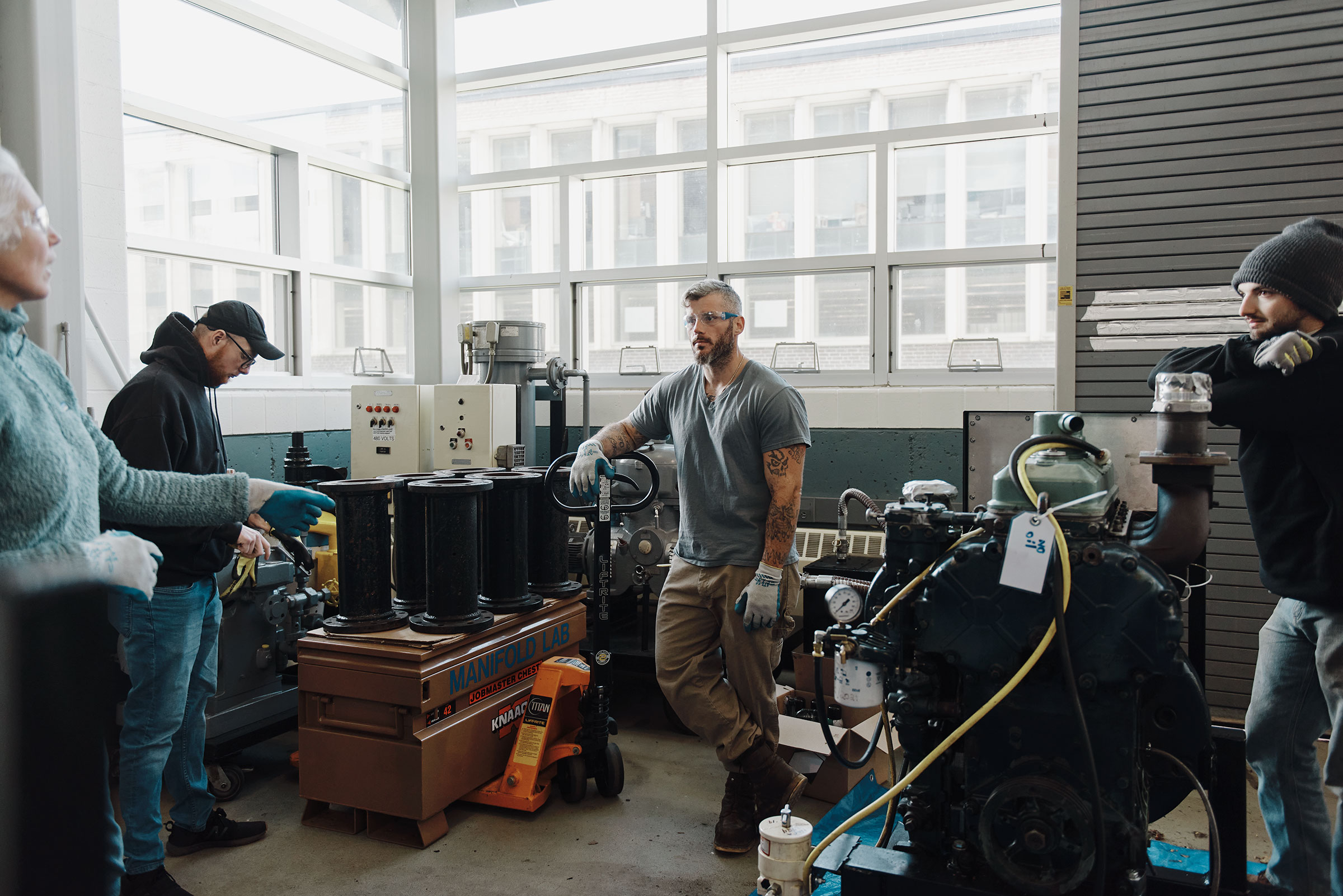 Paul Doolan, Nick Fileccia, and Gerard Mullin during an exercise about moving heavy equipment with instructor Megan Amsler. (Tony Luong for TIME)