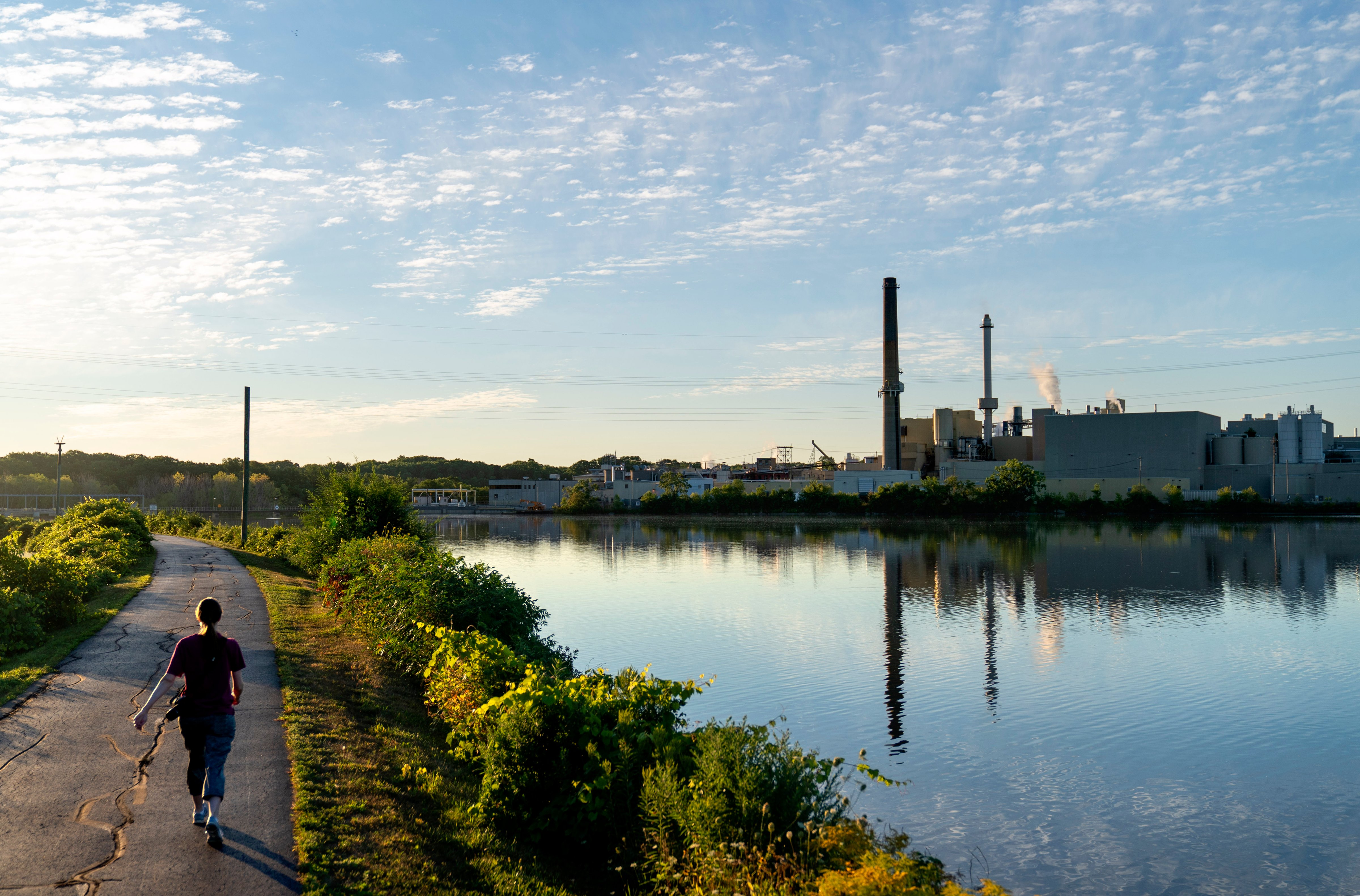 The Midwest Paper Group mill in Combined Locks, Wis., is seen from across the the river in Little Chute, Wis., on Aug. 18, 2020. The mill is one of many that switched its focus from producing paper to cardboard for boxes as online shopping soared. (David Goldman—AP)