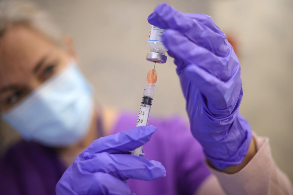 Nurses draw vaccine doses from a vial as Maryland residents receive their second dose of the Moderna coronavirus vaccine at the Cameron Grove Community Center on March 25, 2021 in Bowie, Maryland.