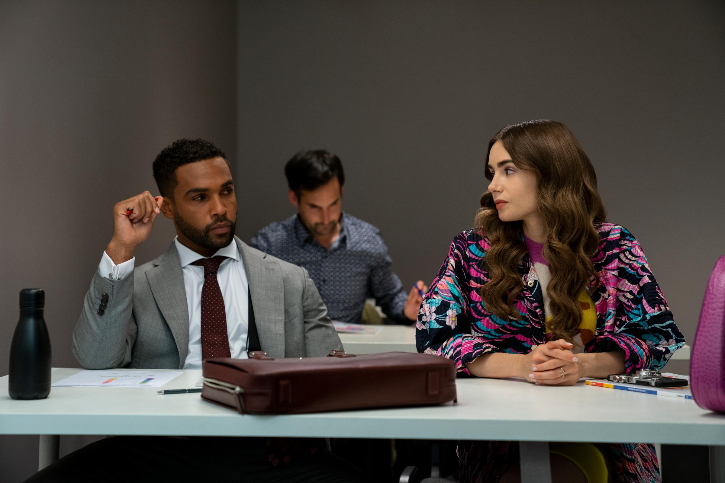 Emily in Paris. (L to R) Lucien Laviscount as Alfie, Lily Collins as Emily in episode 204 of Emily in Paris. Cr. Stéphanie Branchu/Netflix © 2021