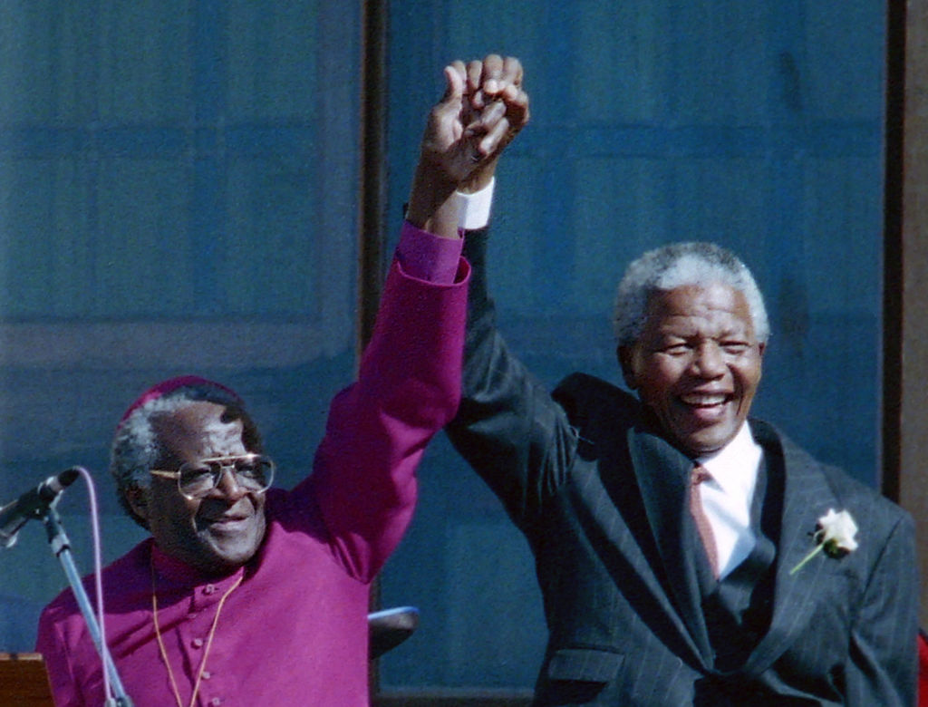 Former South African president Nelson Mandela right held hands with former Bishop Desmond Tutu in Cape Town South Africa, in 1994. File photos of Nelson Mandela during the 1994 elections in South Africa. (Jerry Holt-Star Tribune)