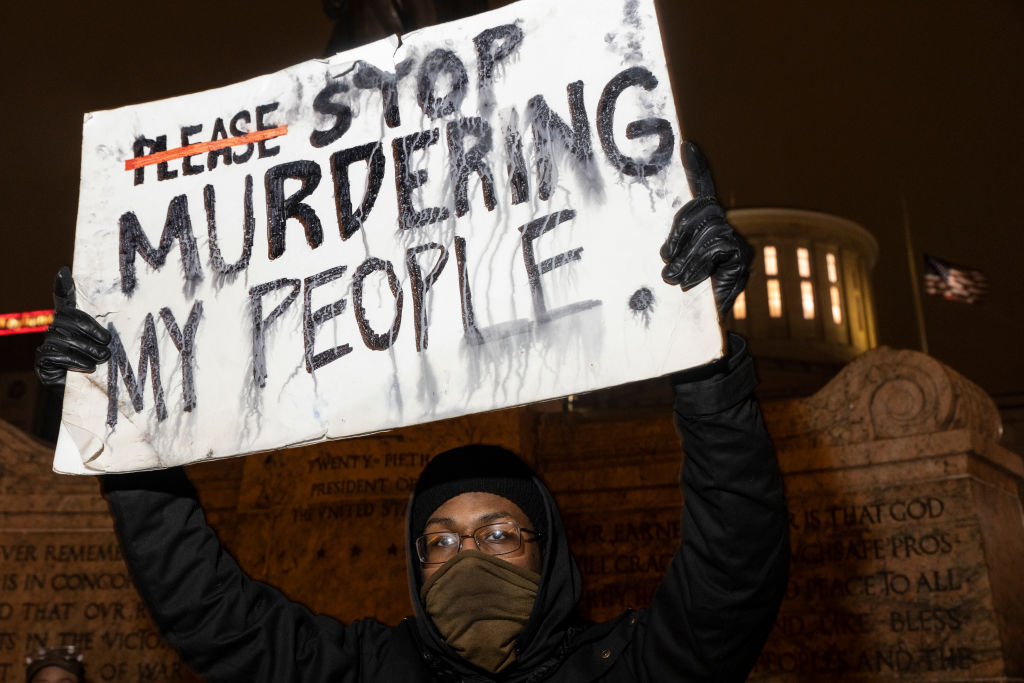 Black Lives Matter activist holds a sign against police brutality in front of the Ohio Statehouse in reaction to the shooting of Makiyah Bryant on April 20, 2021 in Columbus, Ohio. Columbus Police Shot and killed Makiyah Bryant, 16 years old, on April 20, 2021 sparking outrage from the community. (Stephen Zenner-Getty Images)