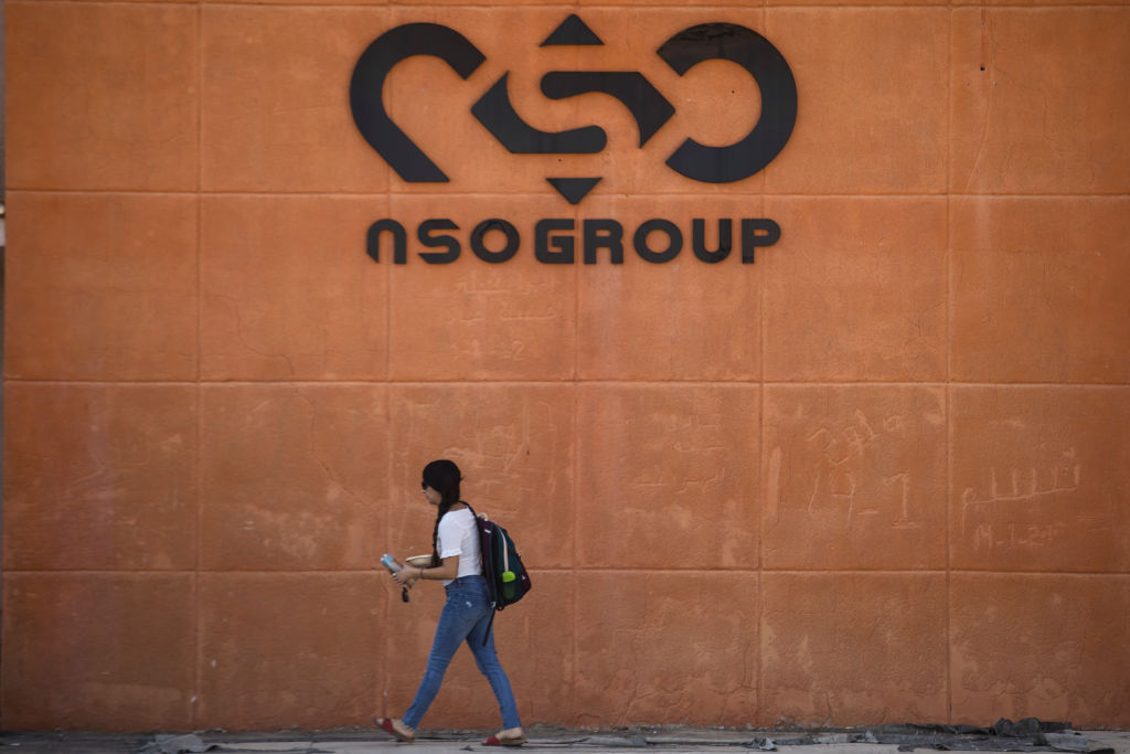 SAPIR, ISRAEL - NOVEMBER 11:  A woman walks by the building entrance of Israeli cyber company NSO Group at one of its branches in the Arava Desert on November 11, 2021 in Sapir, Israel. (Amir Levy/Getty Images)
