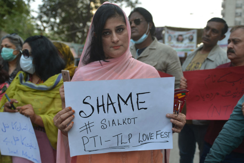 Members of the Joint Action Committee carry placards during a protest in Karachi on December 4, 2021 against the killing of a Sri Lankan factory manager in Sialkot after he was beaten to death and set ablaze by a mob who accused him of blasphemy. (RIZWAN TABASSUM/AFP via Getty Images)