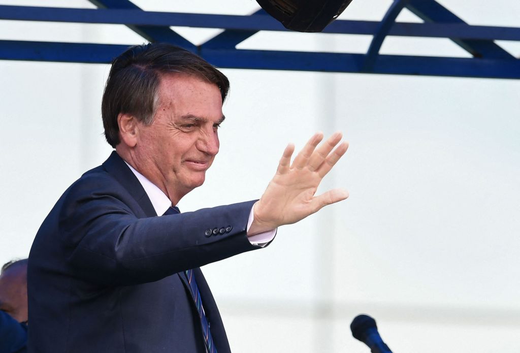 Brazilian President Jair Bolsonaro waves at supporters in Brasilia after joining the right-wing Liberal Party (PL) on November 30, 2021, to seek reelection in the October 2022 polls. (Evaristo Sa—AFP/Getty Images)