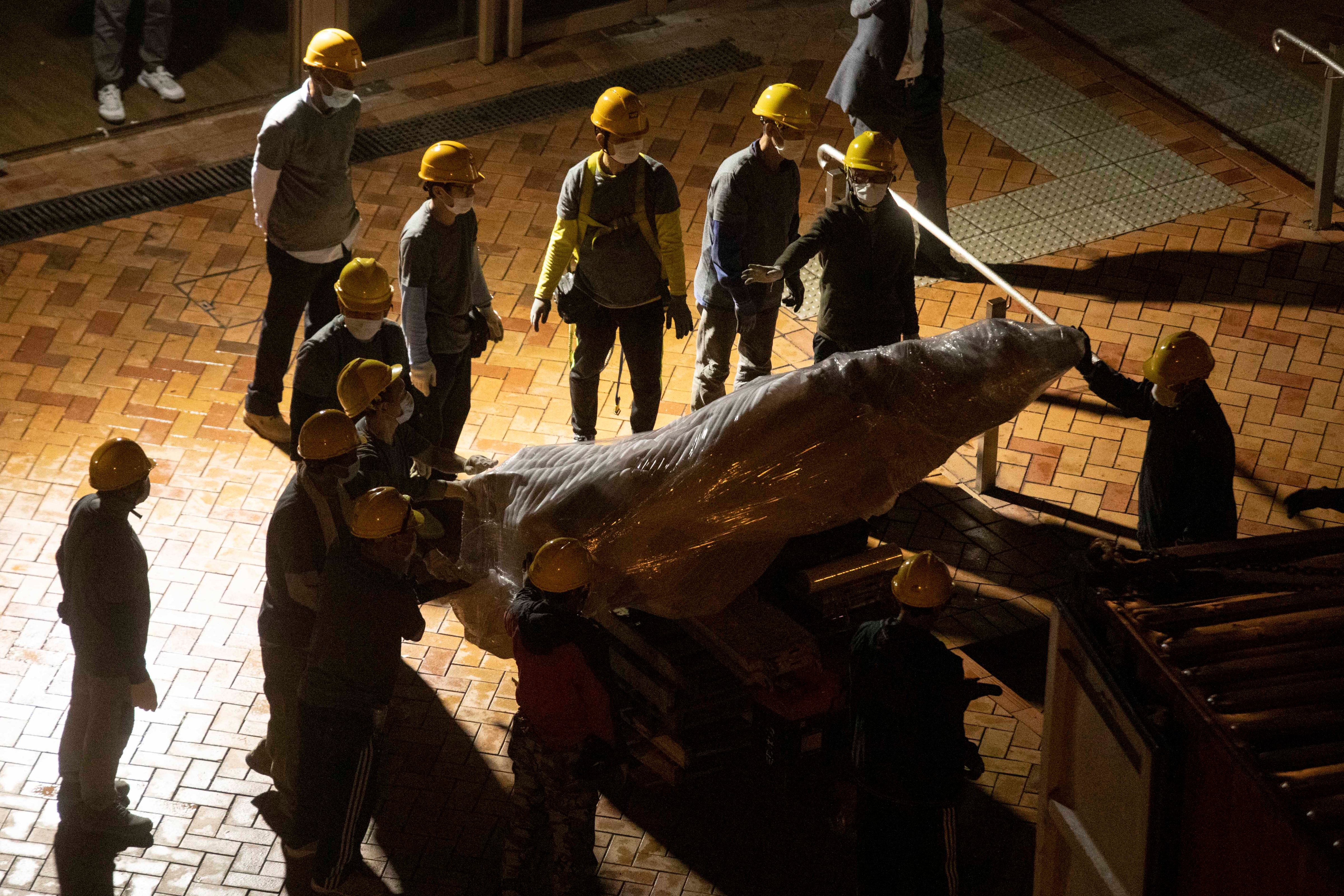 The "Pillar of Shame" statue, a memorial for those killed in the 1989 Tiananmen crackdown, is removed from the University of Hong Kong on Thursday, Dec. 23, 2021. (Lam Chun Tung–The Initium Media/AP)