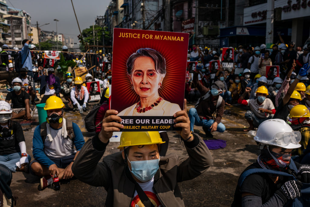 An anti-coup protester holds up a placard featuring de-facto leader Aung San Suu Kyi on March 02, 2021 in Yangon, Myanmar. (Hkun Lat&mdash;Getty Images)
