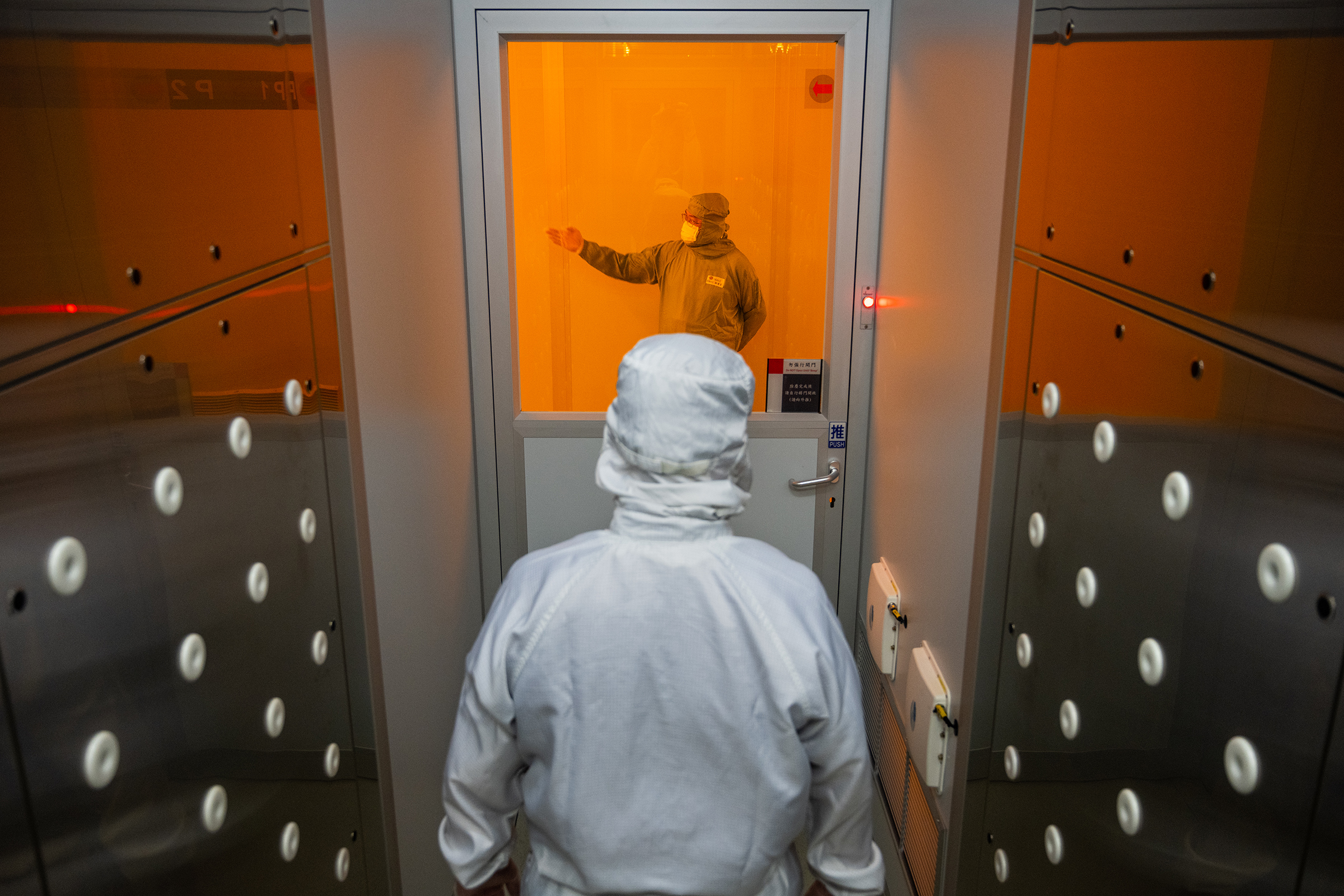 A worker enters a “clean room” at <a href=