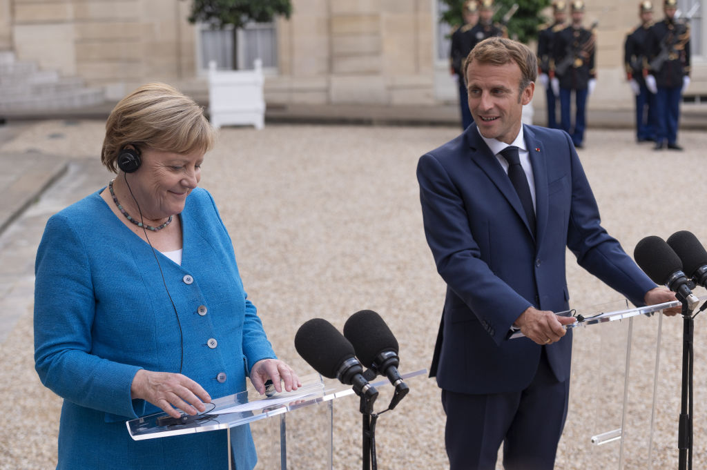 President of France, Emmanuel Macron and former Chancellor of Germany, Angela Merkel, speak to press at the Elysee Palace in Paris, France on Sept. 16 2021. (Julien Mattia—Anadolu Agency/Getty Images)