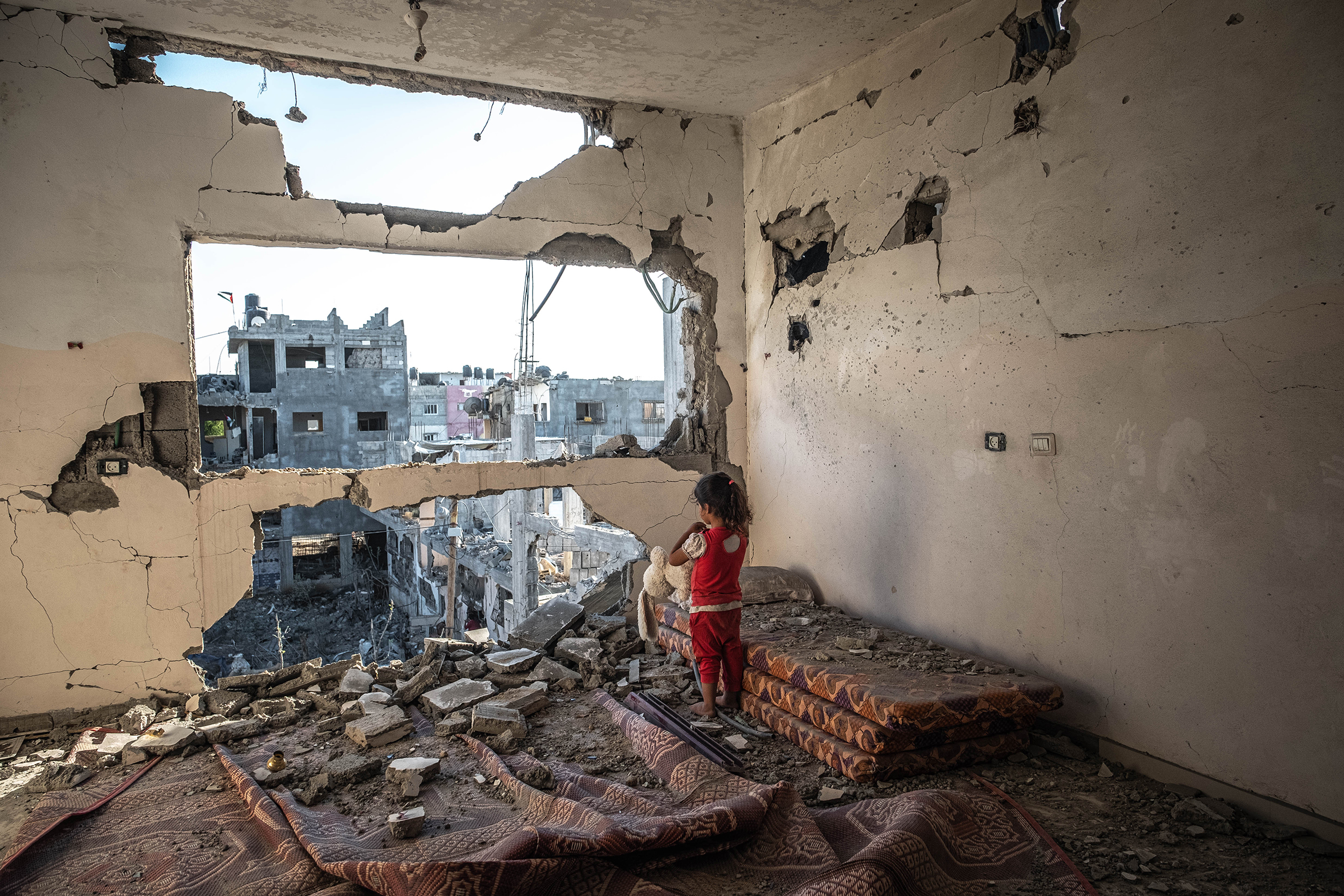 With a cease-fire in effect, a Palestinian girl stands in her destroyed home in Beit Hanoun, Gaza, on May 24. (Fatima Shbair—Getty Images)