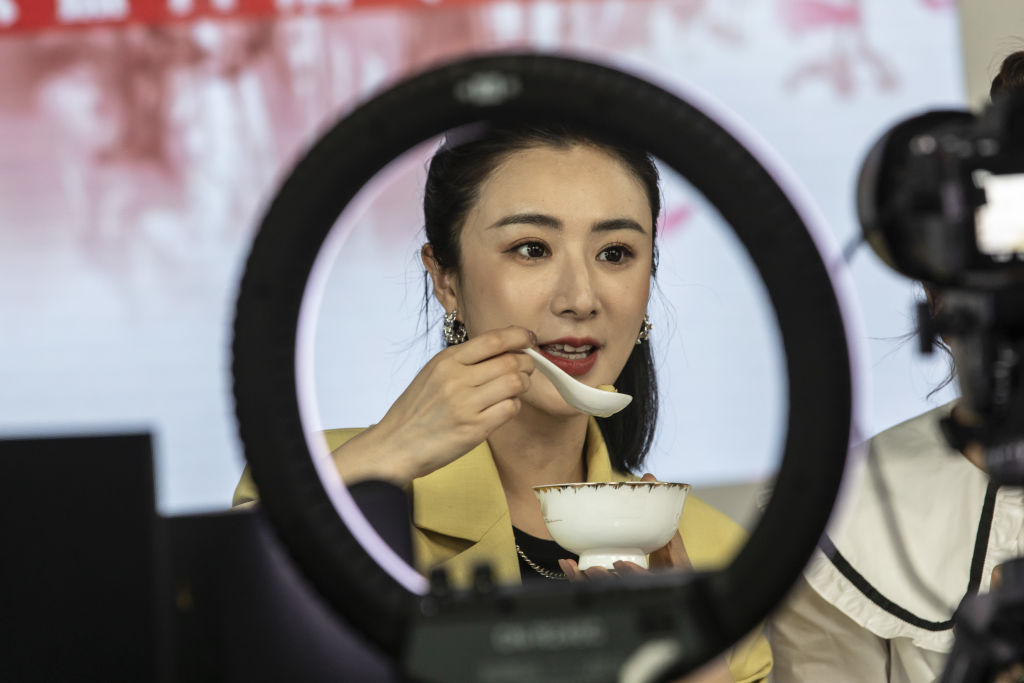 Livestreamer Huang Wei, known professionally as Viya, prepares to sample a bowl of food during a special livestreaming event arranged by Qianxun Group in Wuhan, Hubei Province, China, on Thursday, April 30, 2020. She was ordered to pay 1.34 billion yuan ($210 million) in back taxes, late fees and fines, the State Taxation Administration said in a Dec. 20, 2021 statement. (Qilai Shen—Bloomberg/Getty Images)