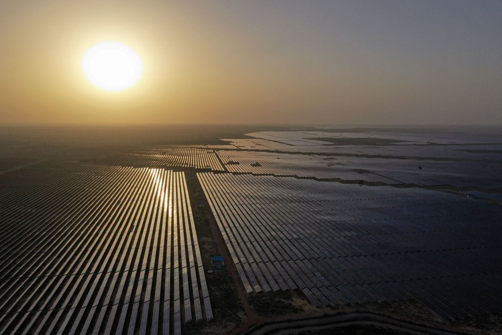This photo taken on October 6, 2021 shows solar panels at the site of solar energy projects developer Saurya Urja Company of Rajasthan Limited, at the Bhadla Solar Park in Bhadla, in the northern Indian state of Rajasthan. (Sajjad Hussain—AFP/Getty Images)