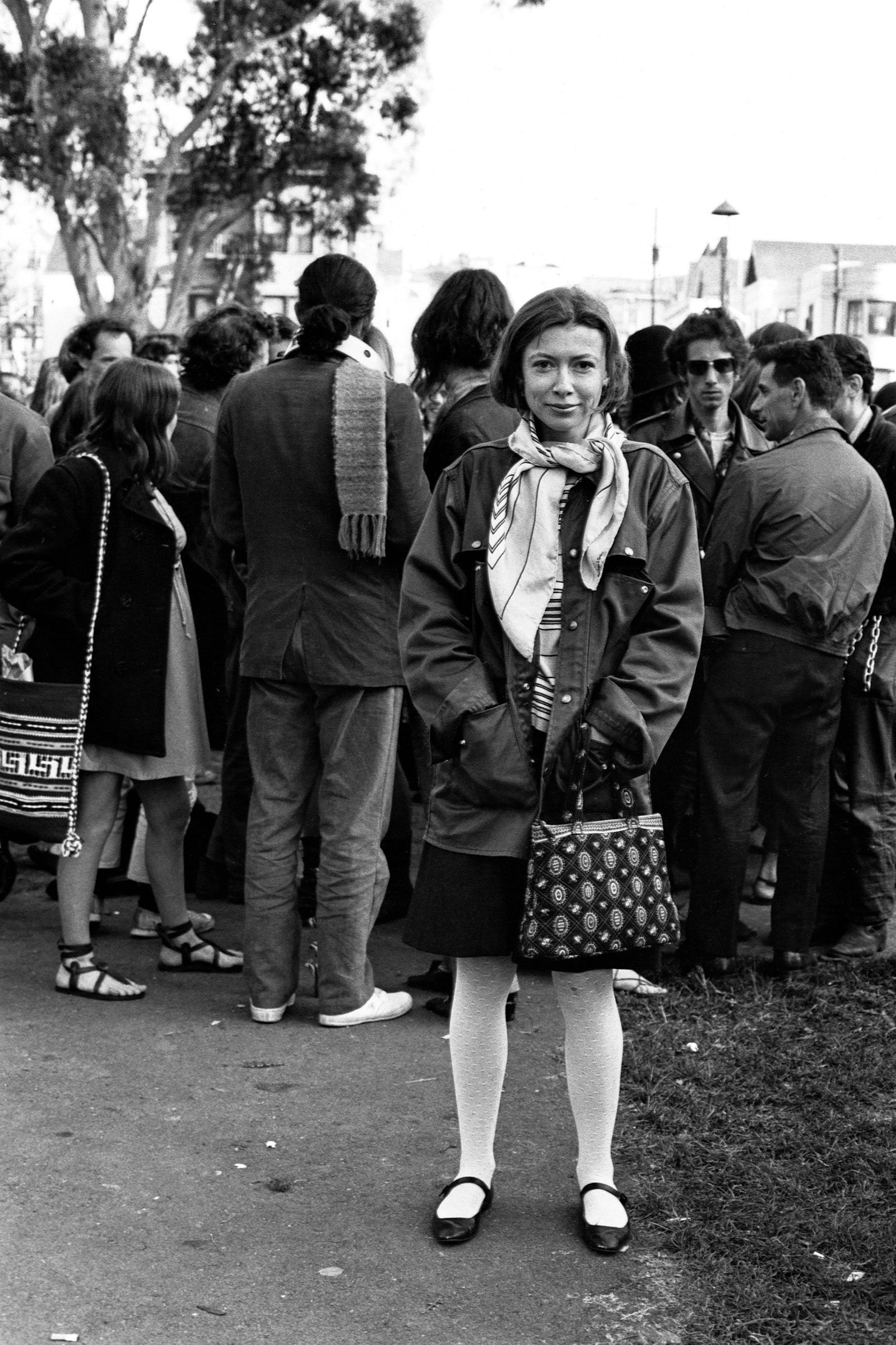 Writer Joan Didion stands at the panhandle of Golden Gate Park with a group of hippies during the writing of her article Slouching Towards Bethlehem. April 1967. (Ted Streshinsky—Corbis/Getty Images)