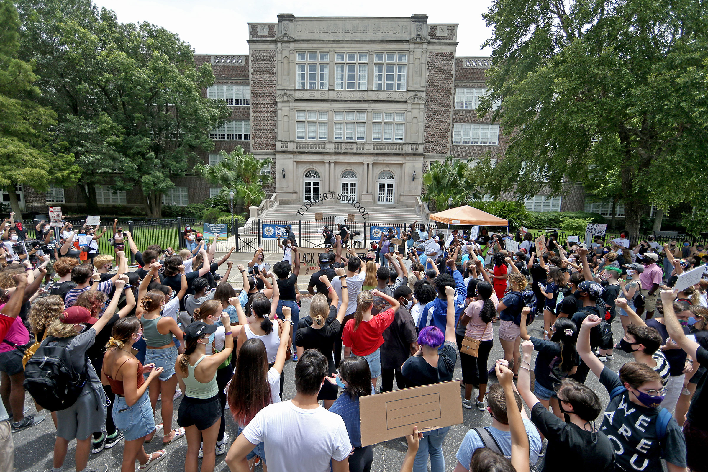 People rally outside the Lusher Charter School—named for  Confederate segregationist Robert Mills Lusher—in New Orleans on July 4, 2020, to demand the school be renamed. (Michael DeMocker—Getty Images)