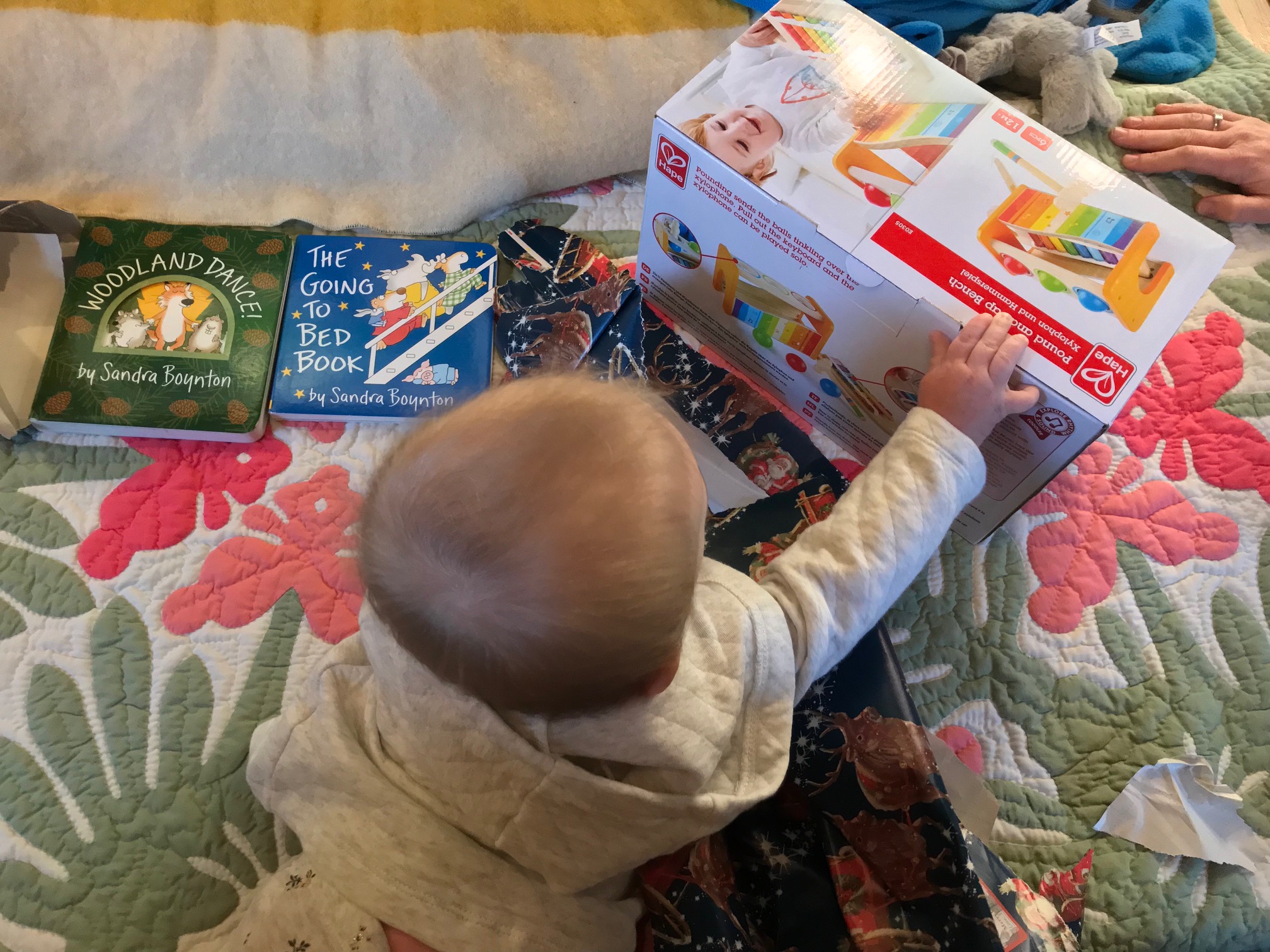The baby in the Salem family opens a holiday gift. (Courtesy photo)