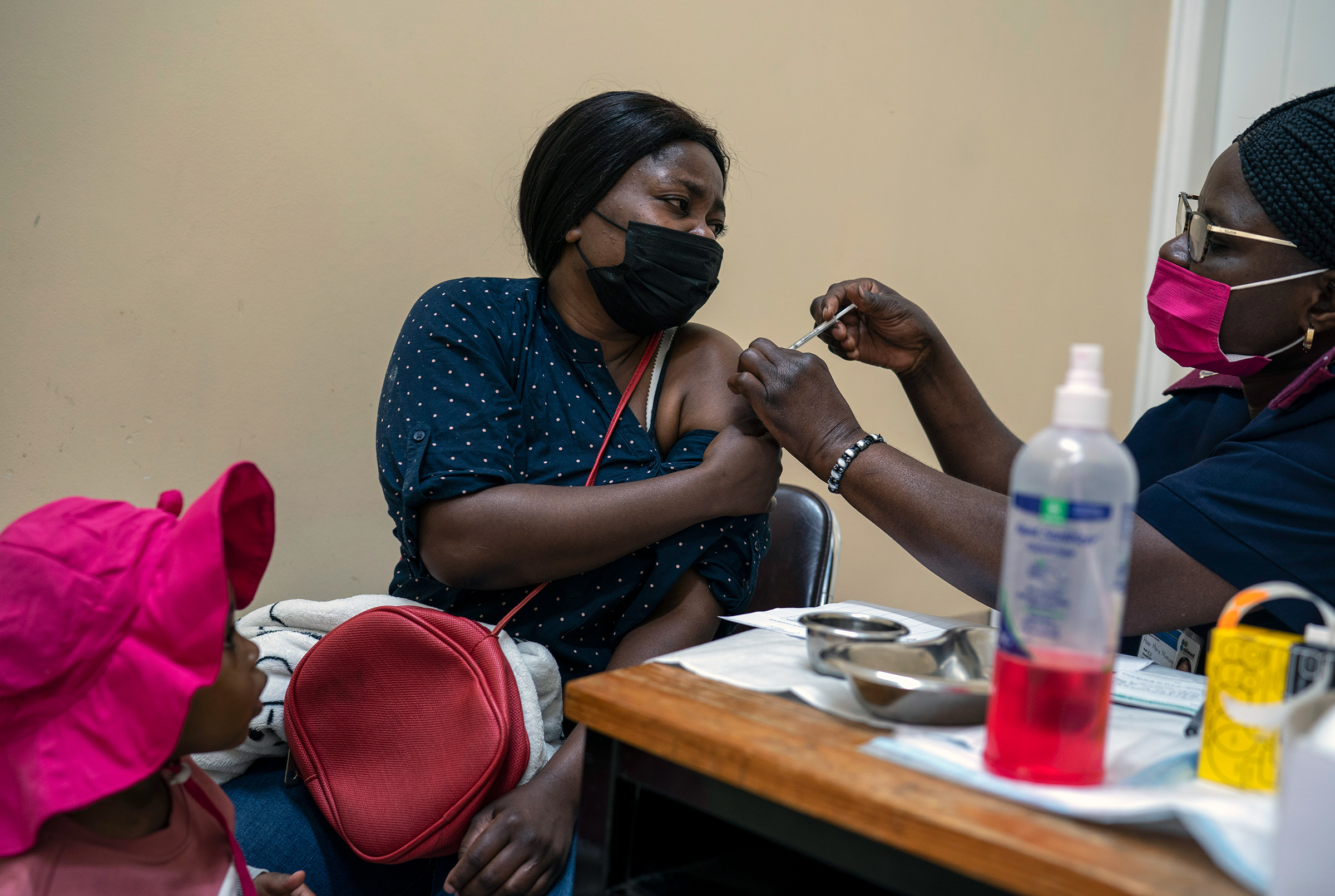 A woman receives a dose of COVID-19 vaccine in Johannesburg, South Africa, on Tuesday, Nov. 30, 2021. Vaccines are finally available in many African countries, but some people there are wary of taking them. (Joao Silva—The New York Times/Redux)
