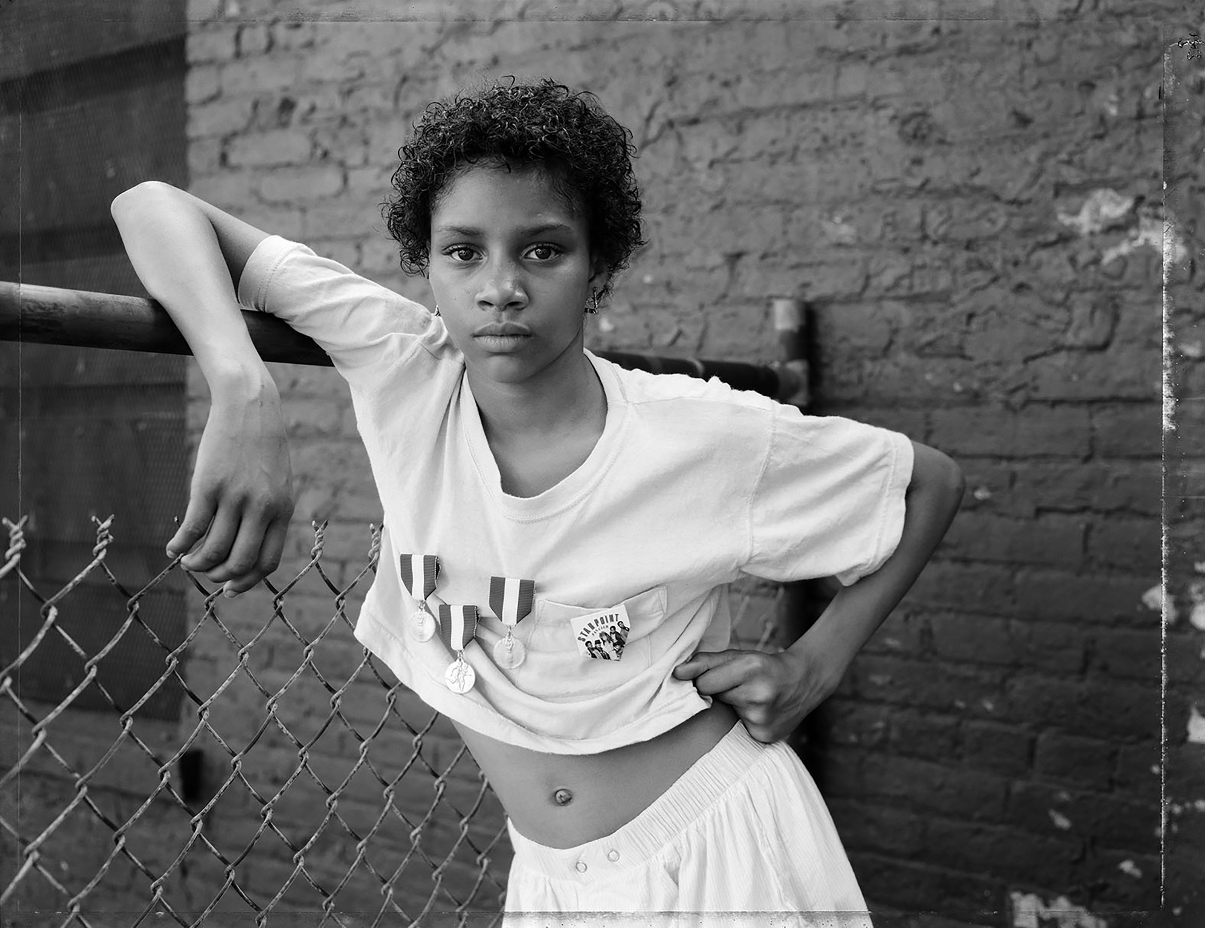 A Girl with School Medals, Brooklyn, NY, 1988, from Street Portraits (Dawoud Bey—MACK)