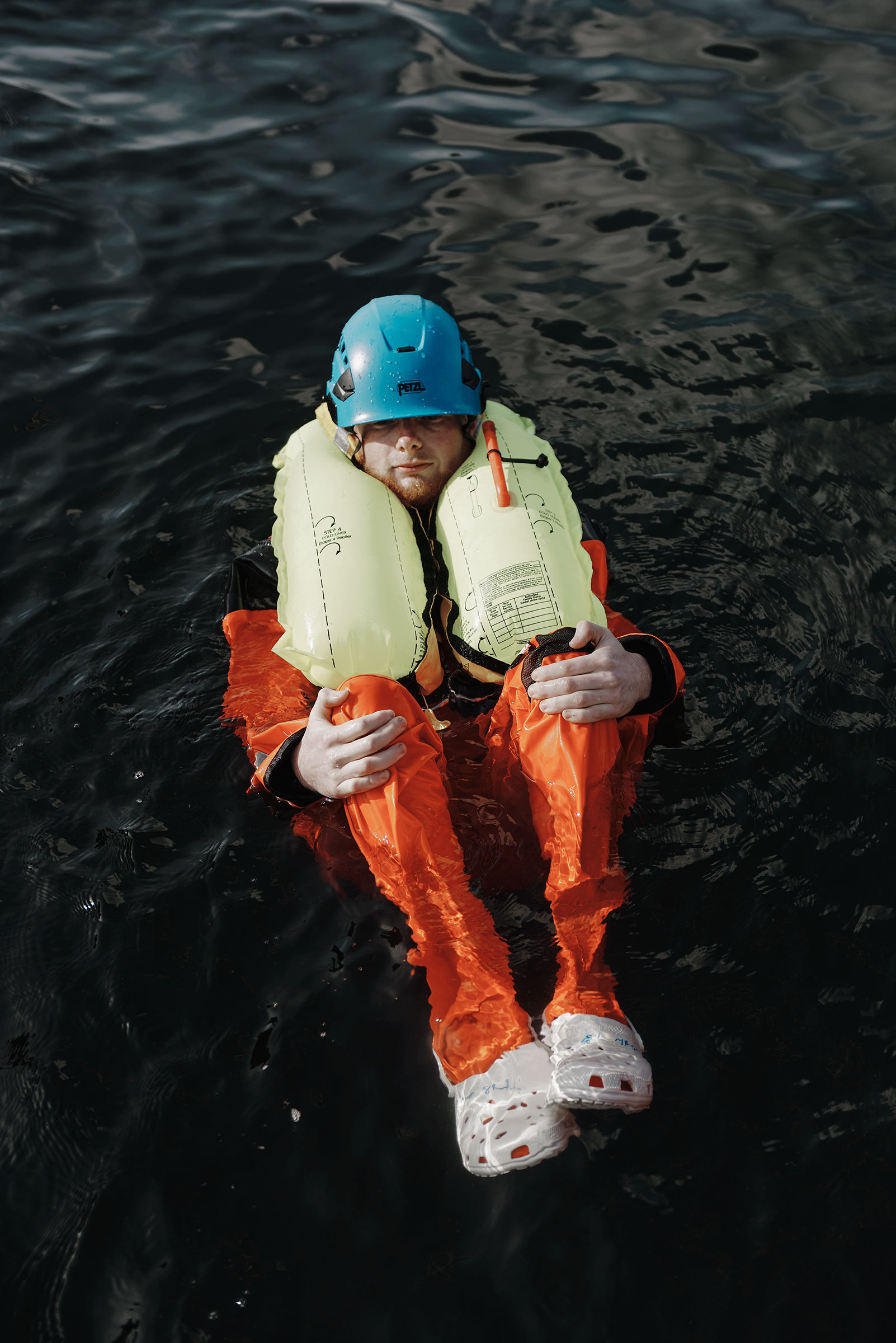 Paul Doolan floats in the water during an emergency survival course at the <a href="https://time.com/6123696/offshore-wind-jobs/">Massachusetts Maritime Academy</a> in Bourne, Mass. (Tony Luong for TIME)
