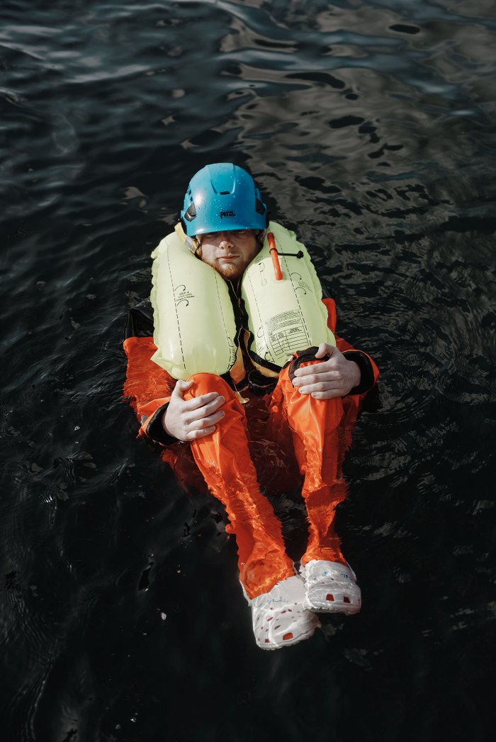 Paul Doolan floating in the water during an exercise aboutemergency survival in at the Massachusetts Maritime Academy inBourne, Massachusetts.