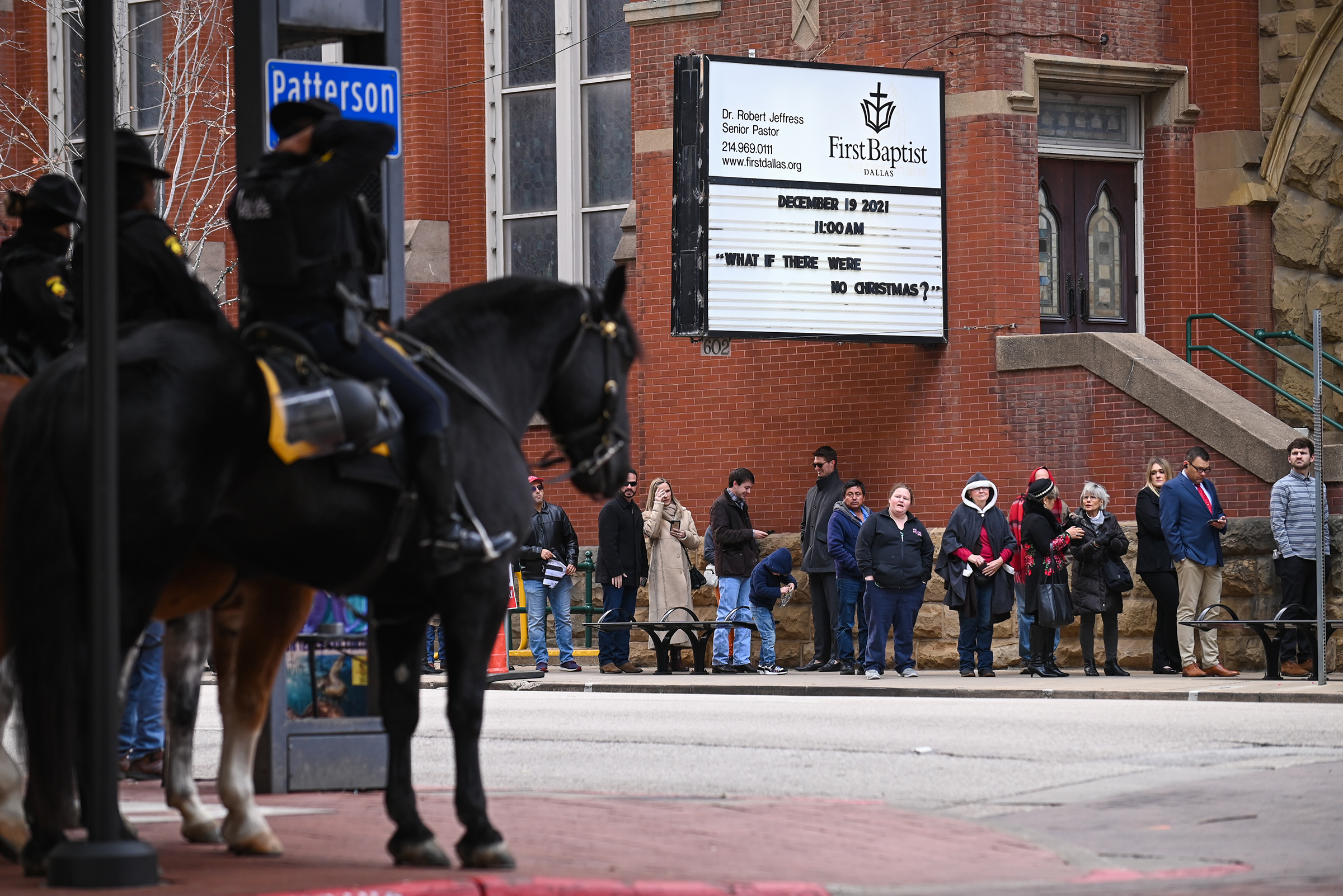 A Dallas Police Mounted Unit stand outside of the old First Dallas Baptist church as Trump supporters and members wait in line for Sunday morning service with former President Donald Trump, on Sunday, Dec. 19, 2021 in downtown Dallas. (Ben Torres)