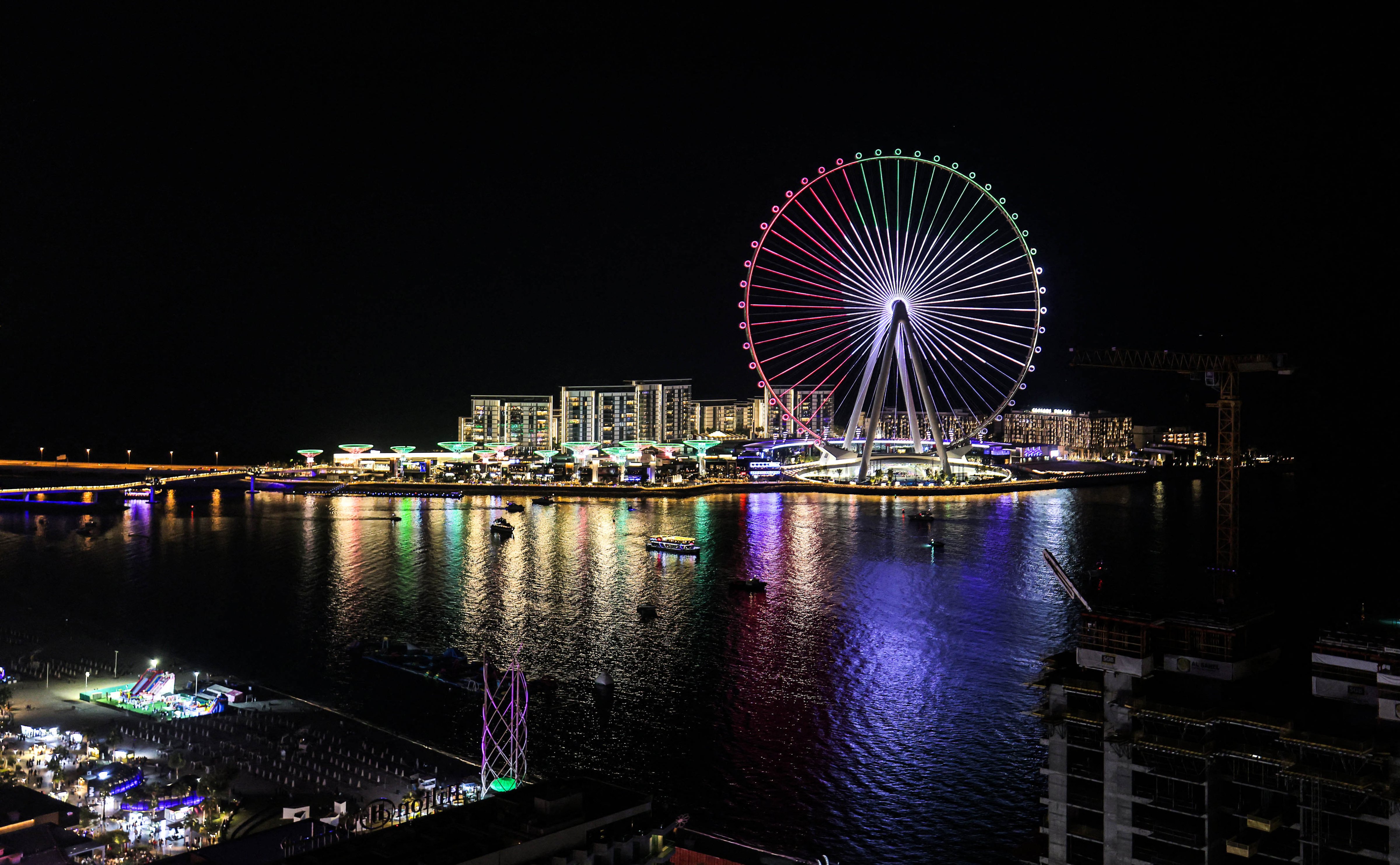 This picture taken on December 1, 2021 shows a view of the Ain Dubai (the Dubai Eye), the worlds largest and tallest observation wheel, lit-up in the colours of the UAE flag in the Gulf emirate marking the United Arab Emirates' 50th jubilee. (GIUSEPPE CACACE—AFP/Getty Images)