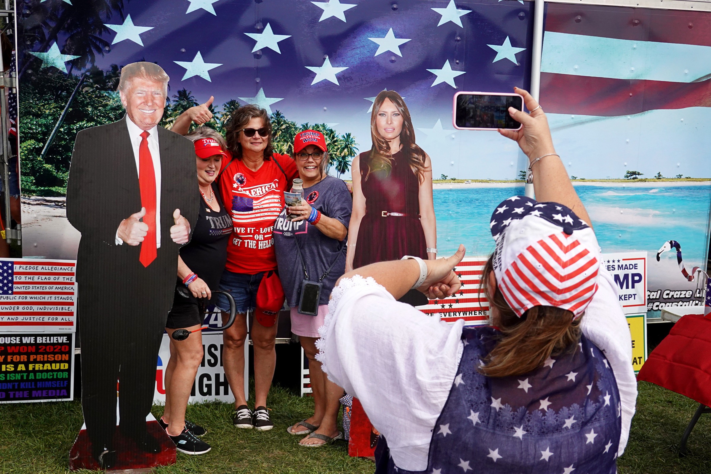 Attendees of a Trump rally in Des Moines, Iowa, pose with cardboard cutouts on Oct. 9, 2021. (Scott Olson—Getty Images)