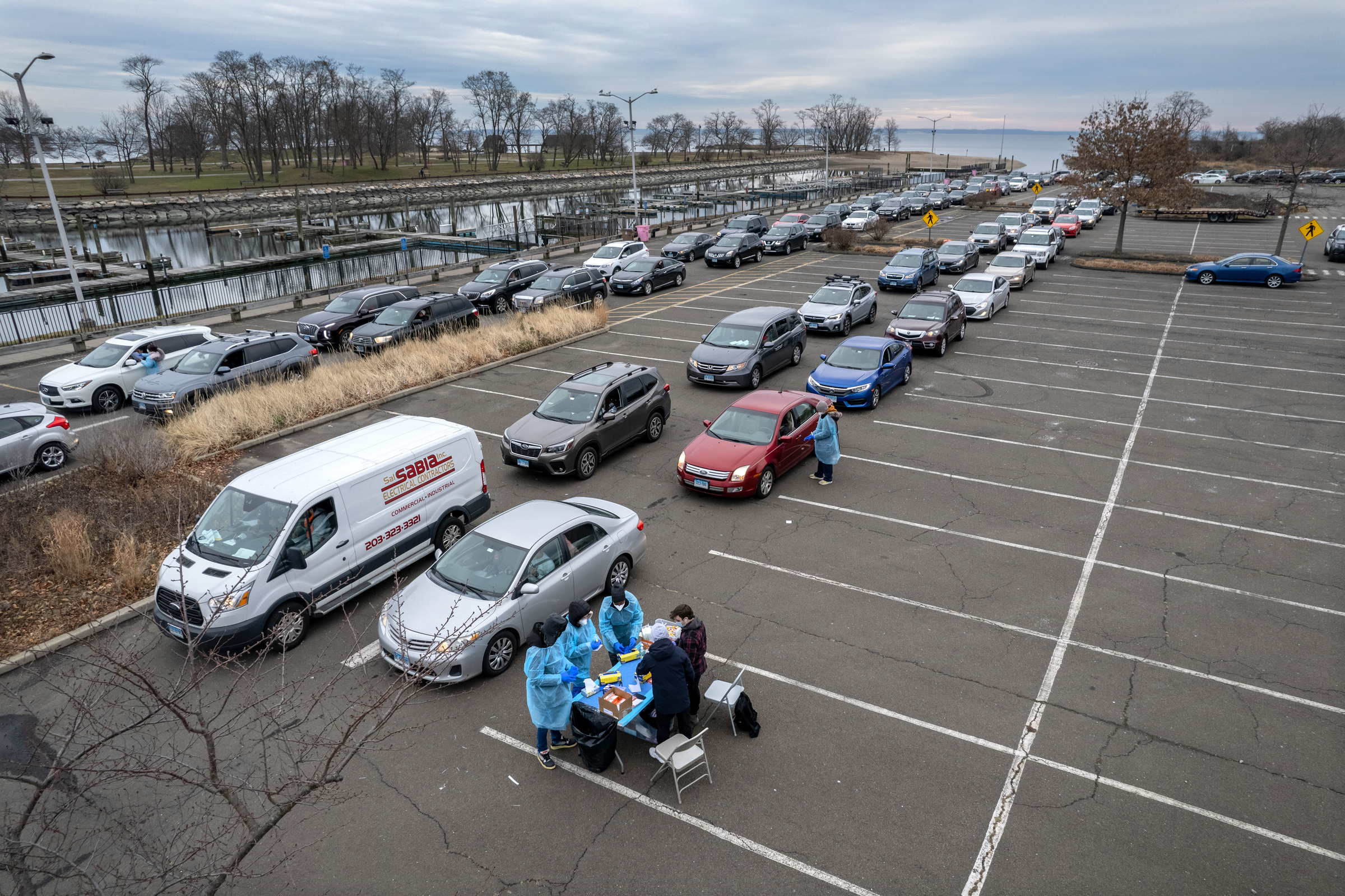 In an aerial view, health workers administer COVID-19 PCR tests at an outdoor testing site in Stamford, Conn., on Dec. 28, 2021. (John Moore—Getty Images)