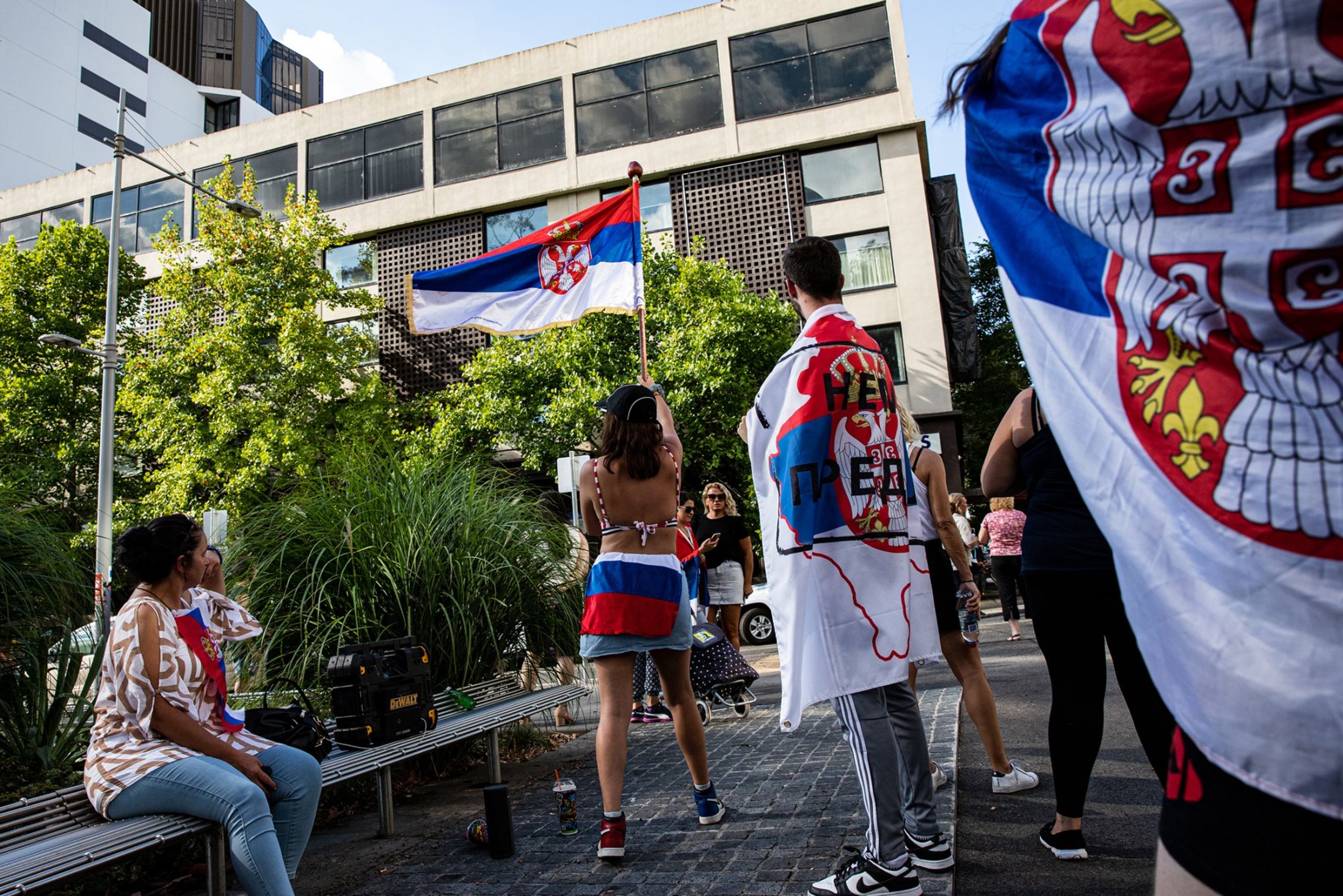 Supporters gather outside the Park Hotel where Novak Djokovic was taken pending his removal from the country after his visa was cancelled by the Australian Border Force on Jan. 6, 2022 in Melbourne, Australia. (Diego Fedele/Getty Images)