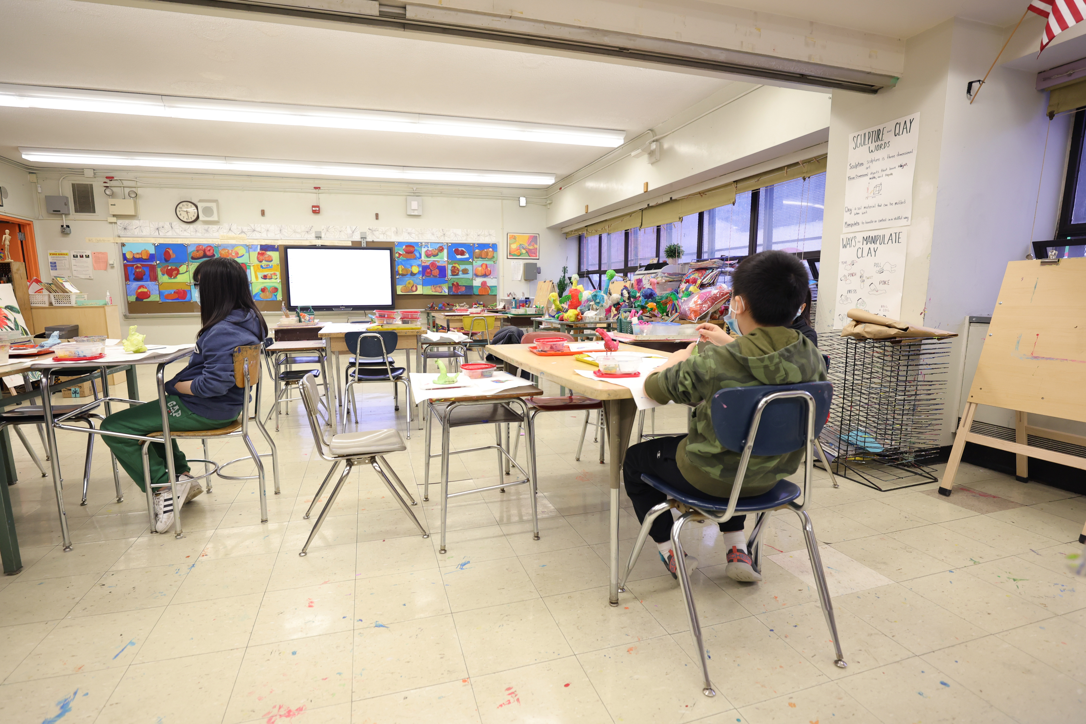 Masked students in an art class at Yung Wing School P.S. 124 on Jan. 05, 2022 in New York City. Mayor Eric Adams is keeping classrooms open for in-person lessons despite high student and teacher absentee rates due to the surge in Omicron cases. (Michael Loccisano—Getty Images)